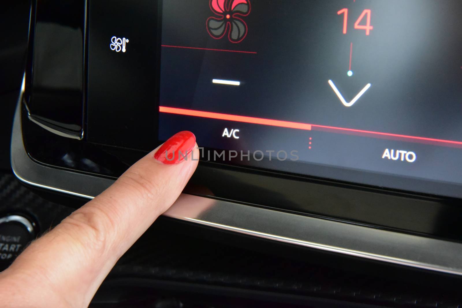 Female finger on the button to activate the air conditioning in the car by aselsa