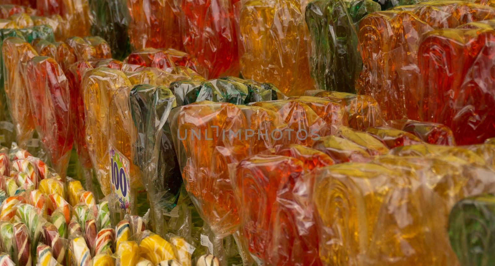 Counter with multicolored sweet lollipops of different shapes