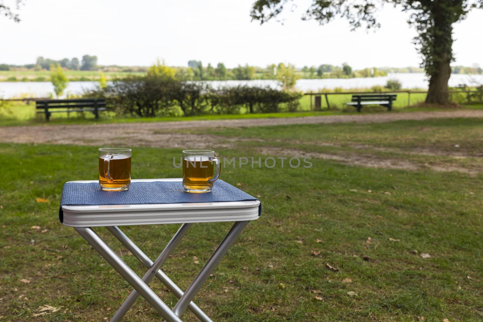 two glasses of tea during afternoon break outside on a table on the river Maas