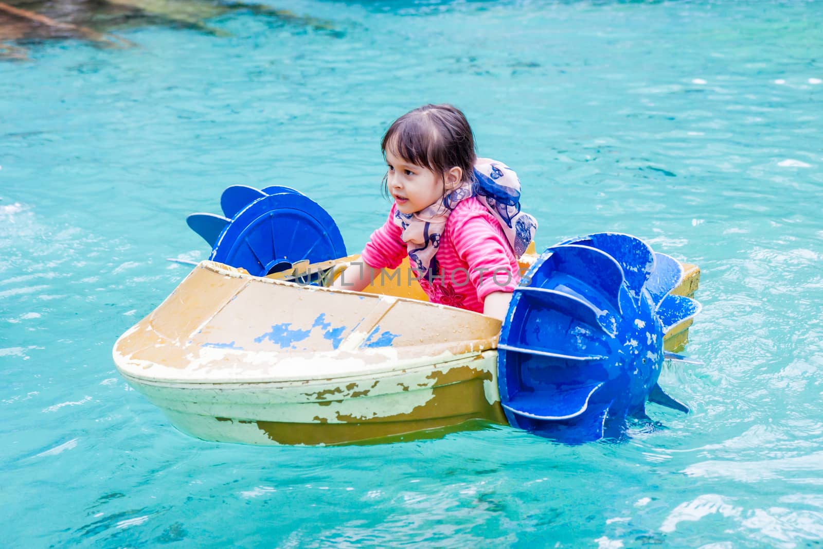 Young girl in hand paddle boat