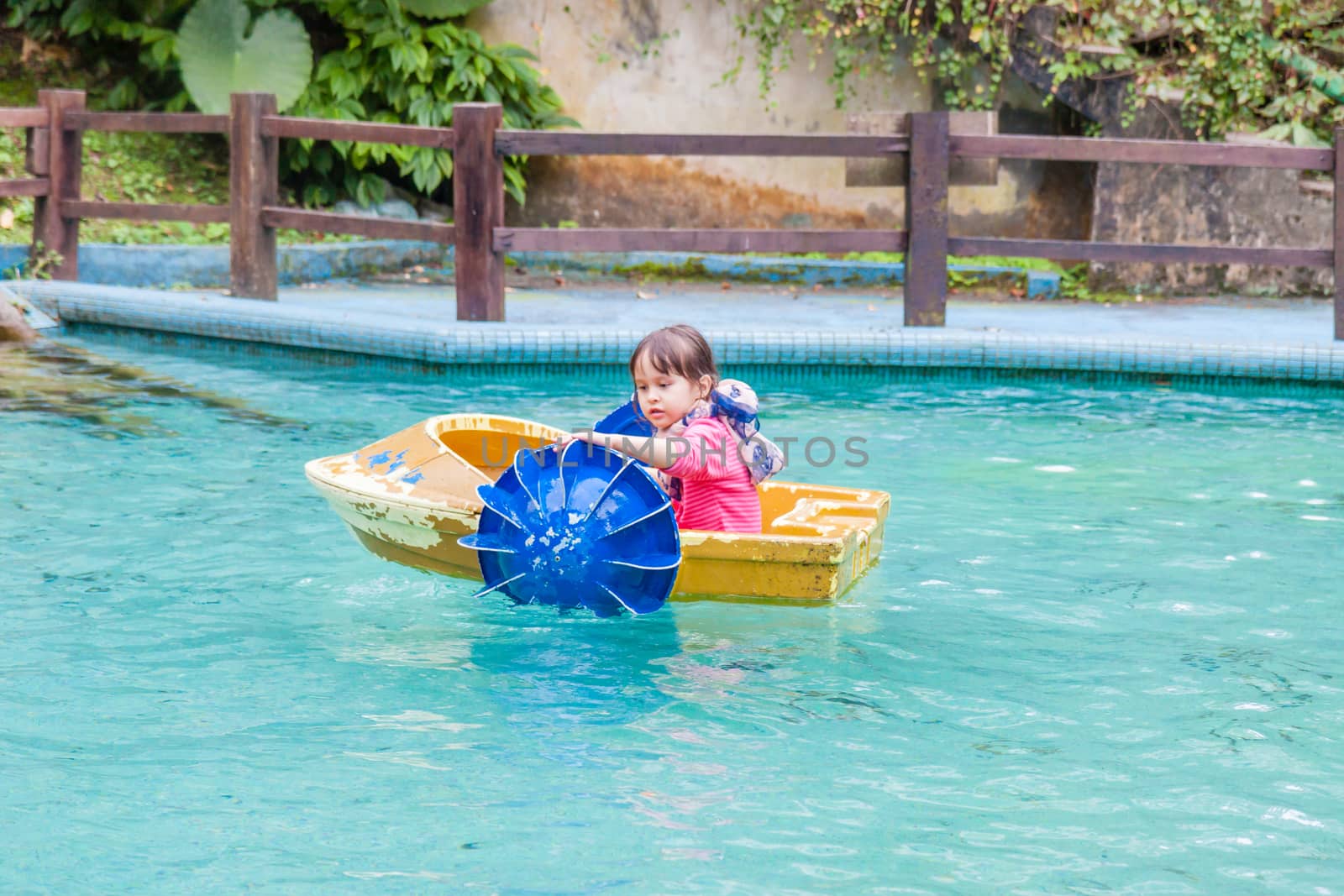Young girl in paddle boat by imagesbykenny