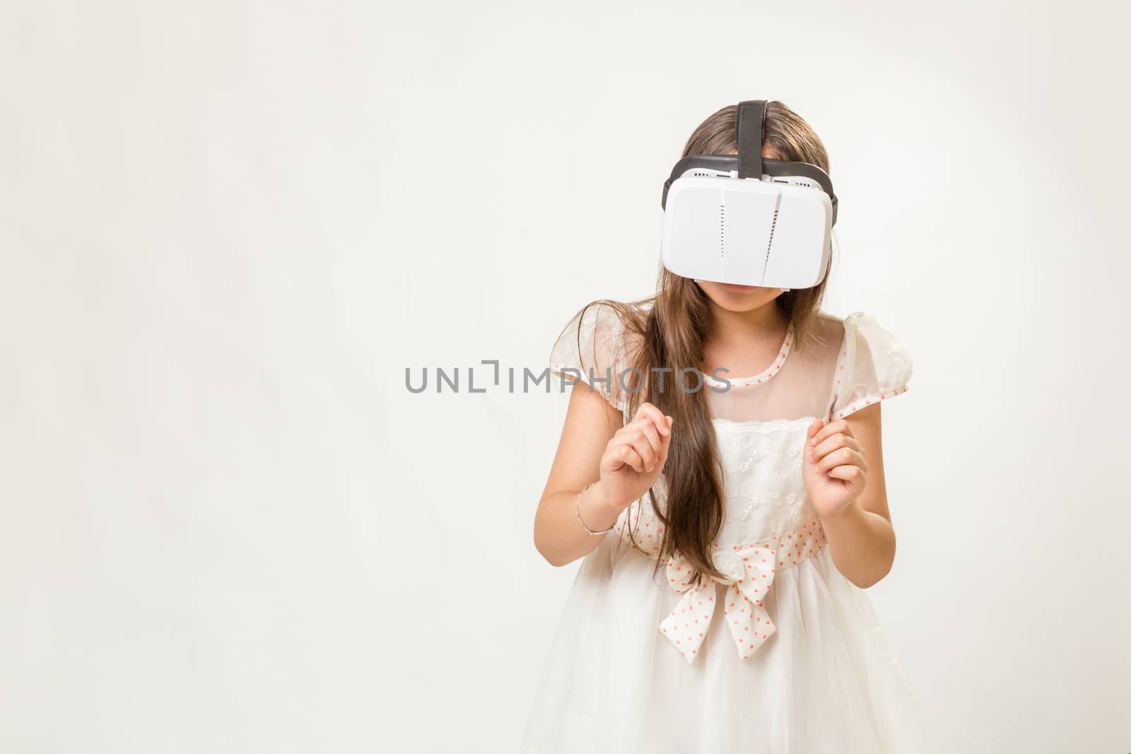 Young girl wearing virtual reality VR goggles