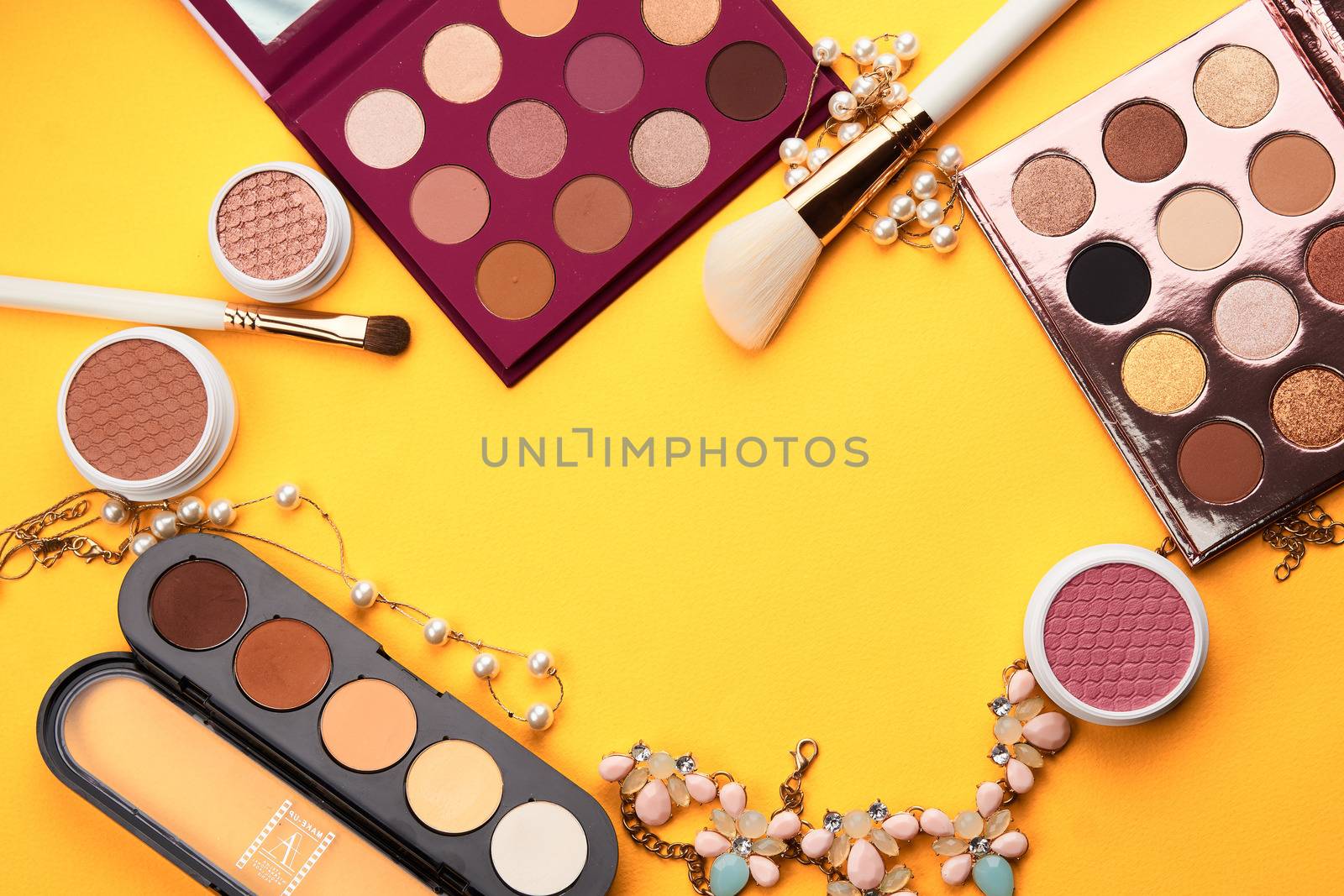 eyeshadow professional cosmetics blush powder yellow background top view by SHOTPRIME