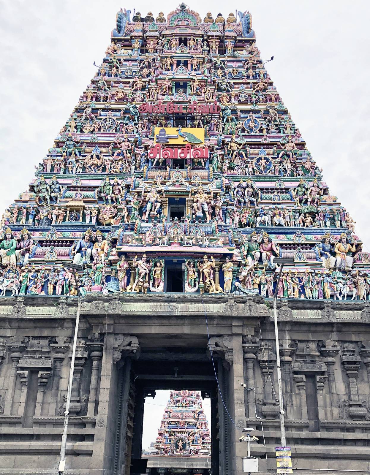 Tower of an ancient temple with beautiful sculptures and statue painted with blue sky background