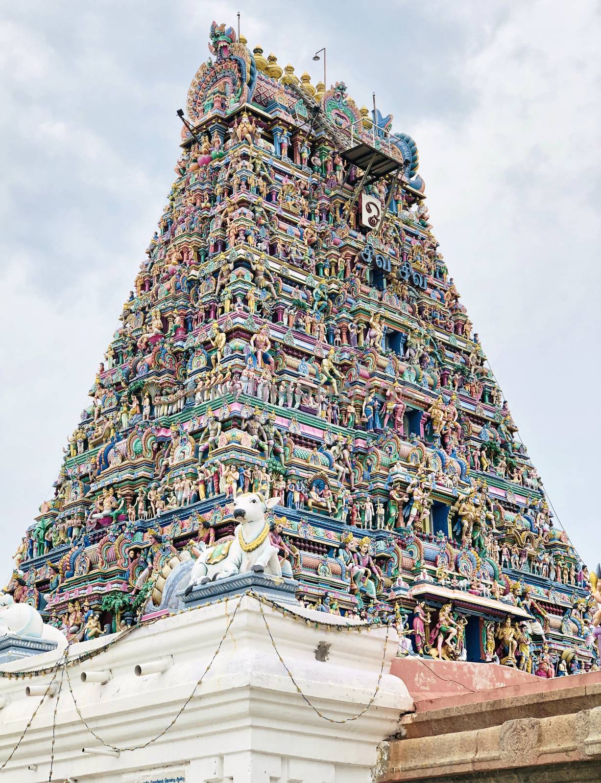 Tower of an ancient temple with beautiful sculptures and statue painted with blue sky background