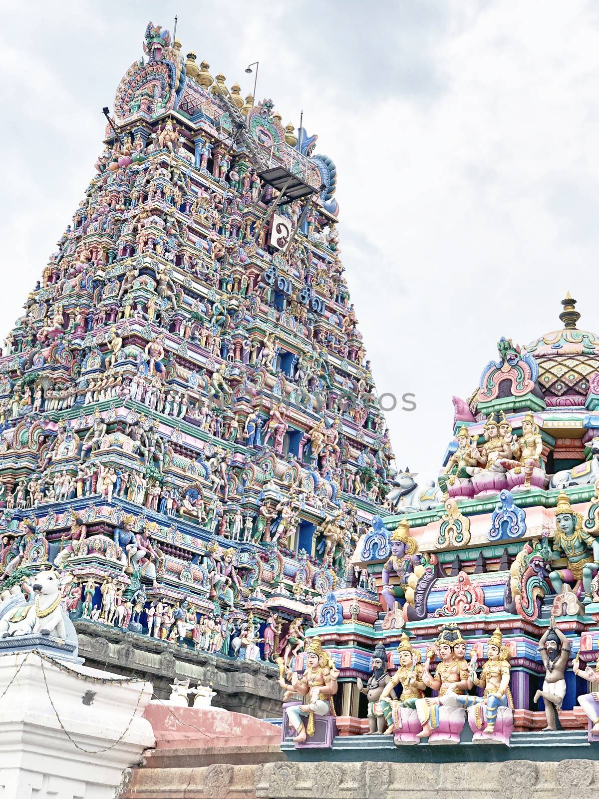 Tower of an ancient temple with beautiful sculptures and statue painted with blue sky background