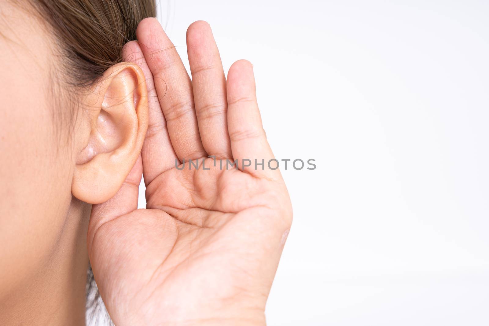 woman hearing loss or hard of hearing and cupping her hand behind her ear isolate on white background, Deaf concept.
