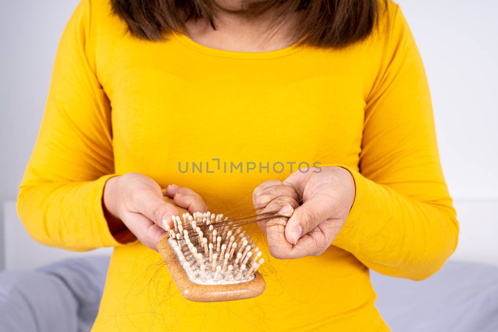 Hair fall problem, closeup hand holding comb and problem hair. Healthcare medical or daily life concept.