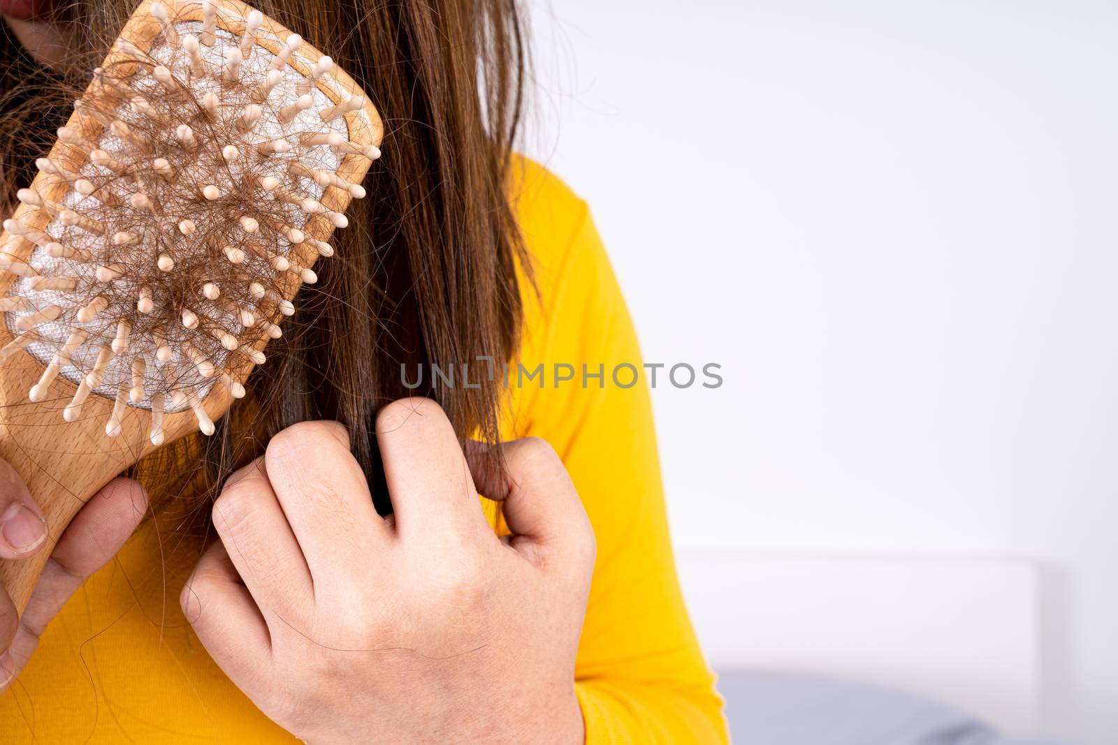 Hair fall problem, closeup hand holding comb and problem hair. Healthcare medical or daily life concept.