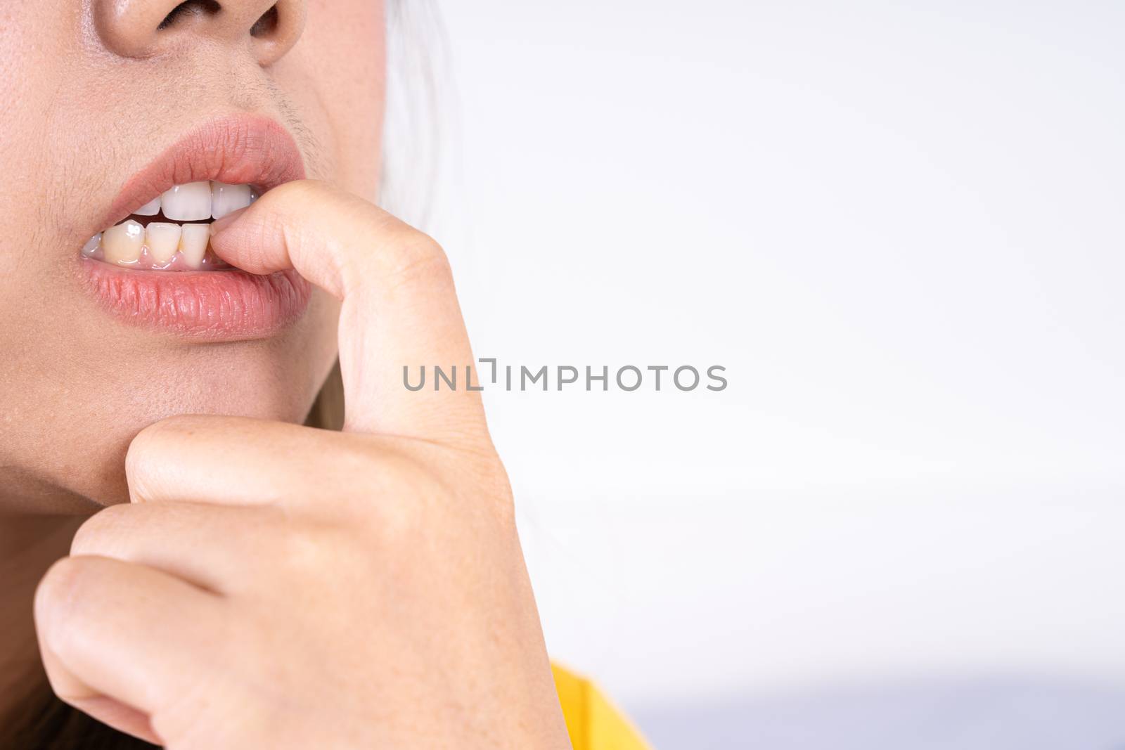 close up nervous woman biting her nails, stressful woman gnawing her nails. by mikesaran