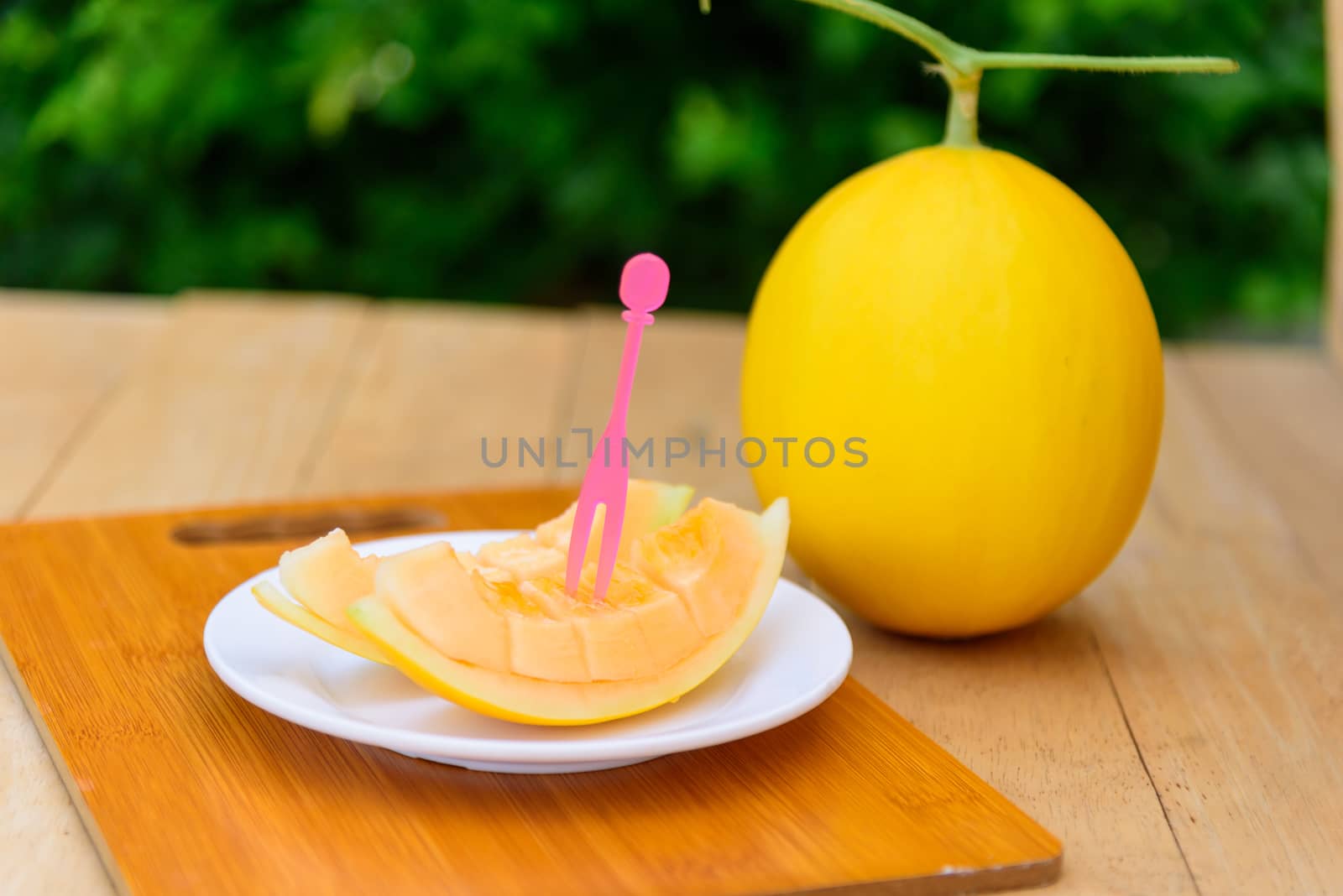 fresh golden melon on wood plate by rukawajung