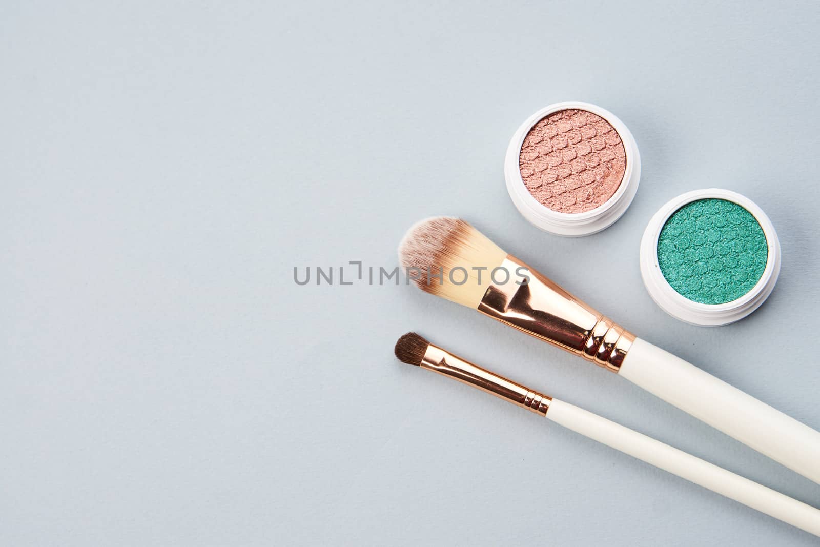 eyeshadow accessories beads makeup brushes collection professional cosmetics on gray background. High quality photo