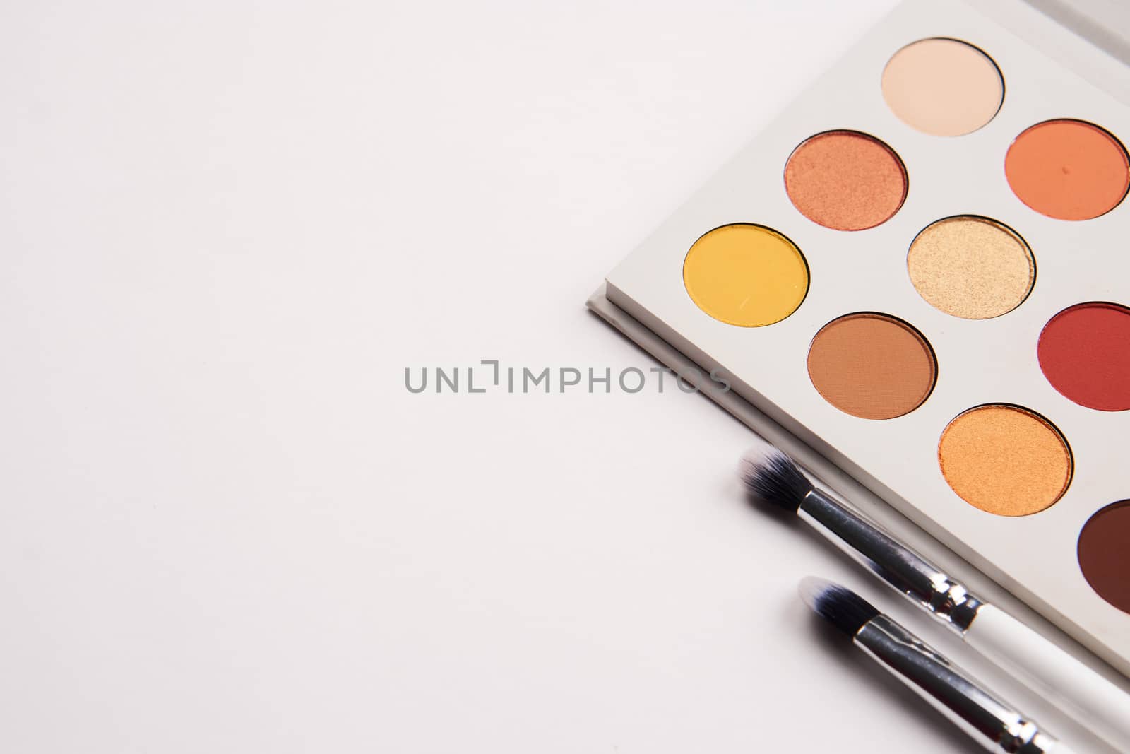 eyeshadows on isolated background and makeup brushes professional cosmetics. High quality photo