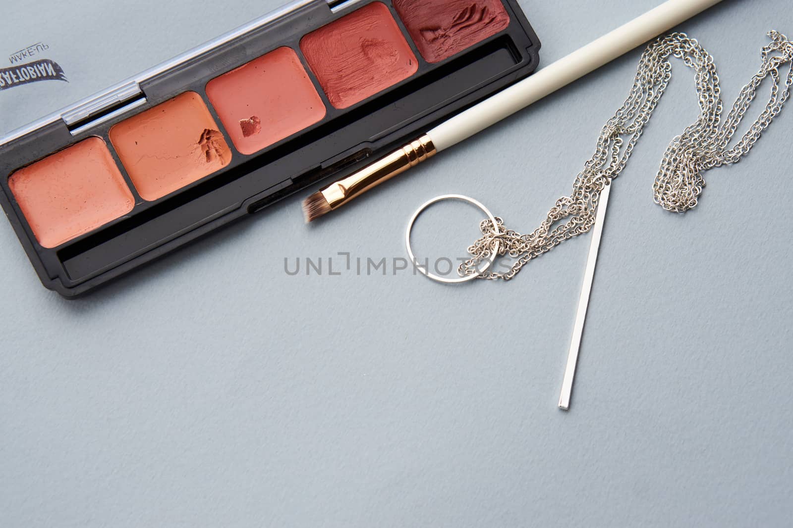 Eyeshadows and brushes on a stand gray background decoration professional cosmetics. High quality photo