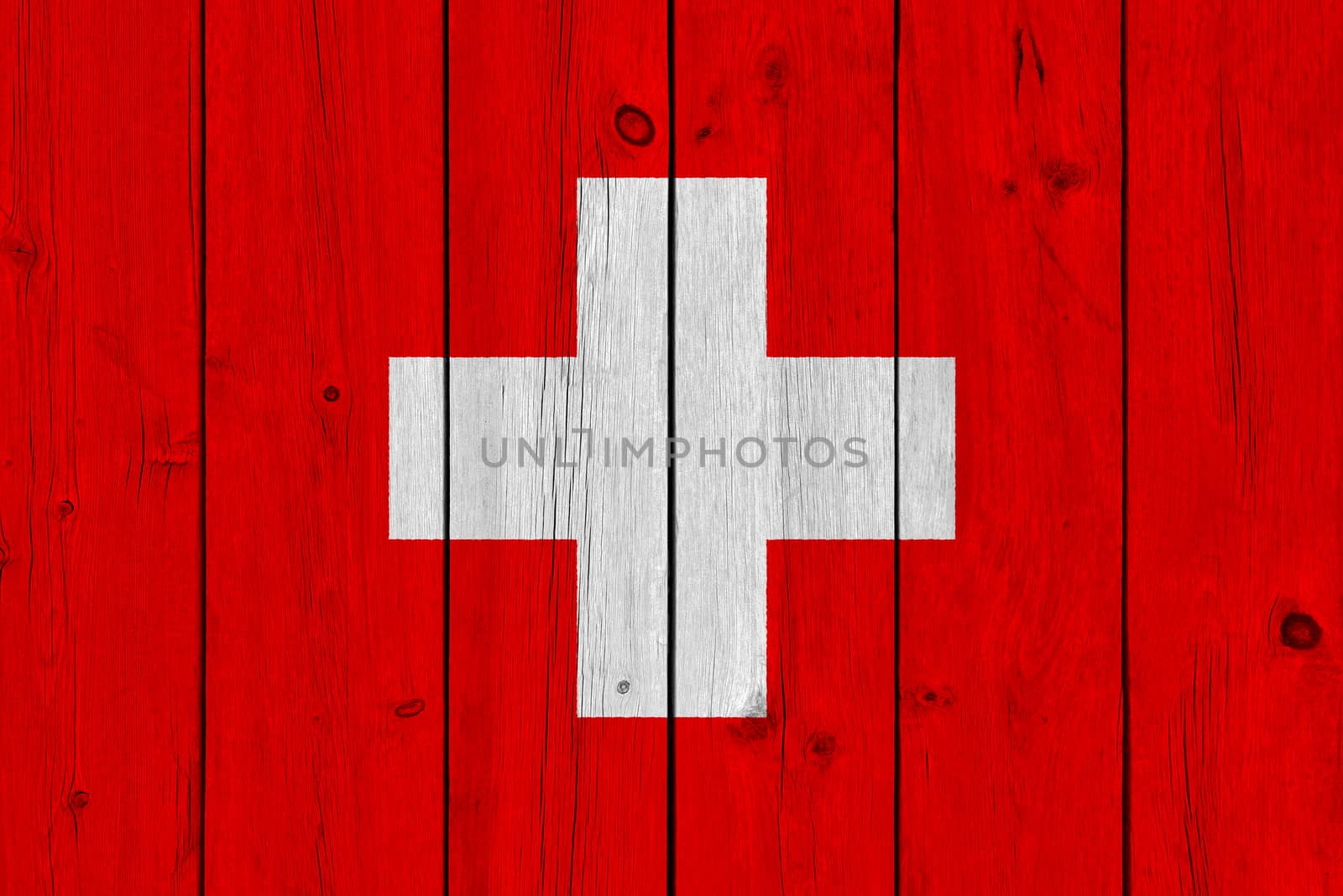 Switzerland flag painted on old wood plank. Patriotic background. National flag of Switzerland