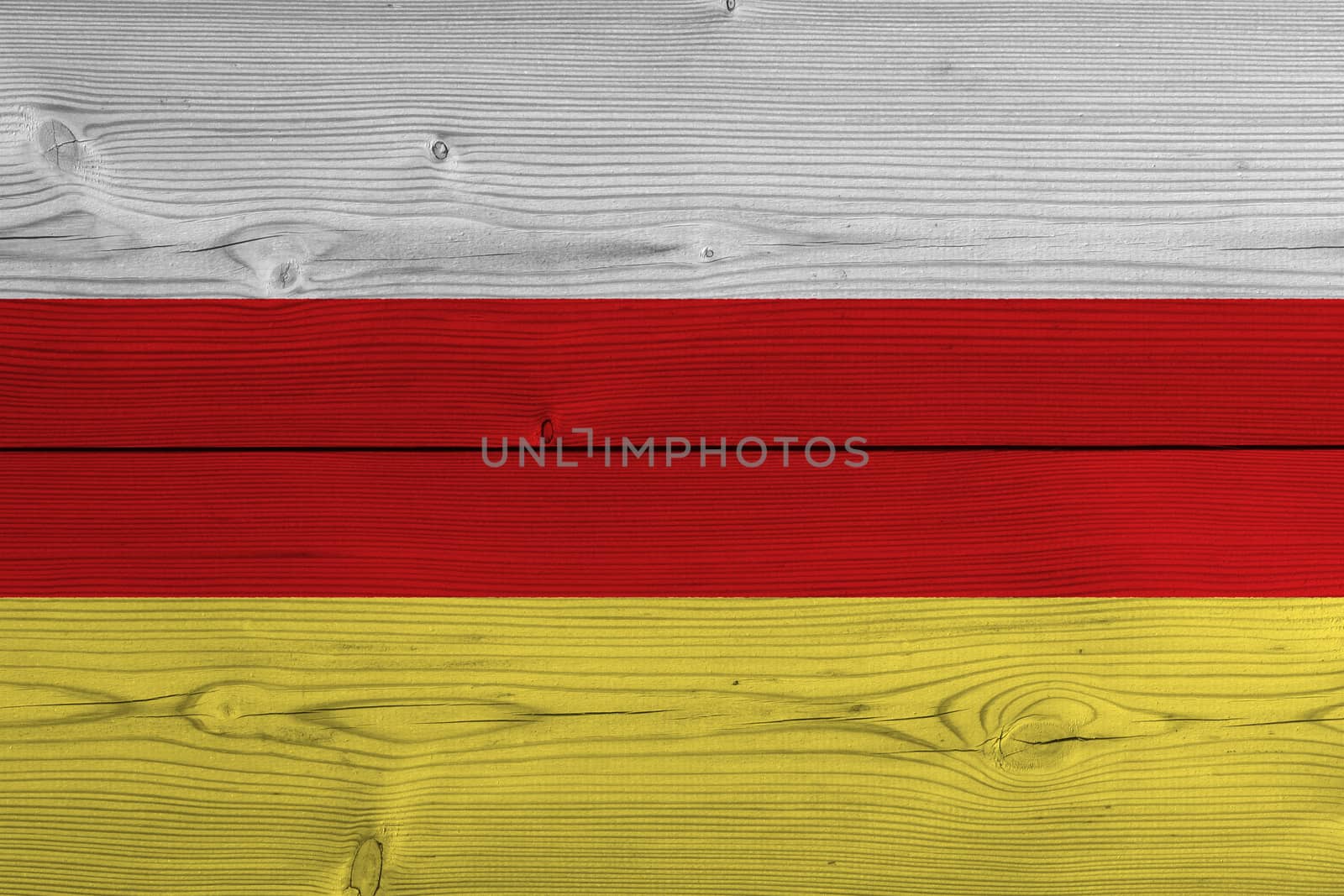 South ossetia flag painted on old wood plank. Patriotic background. National flag of South ossetia