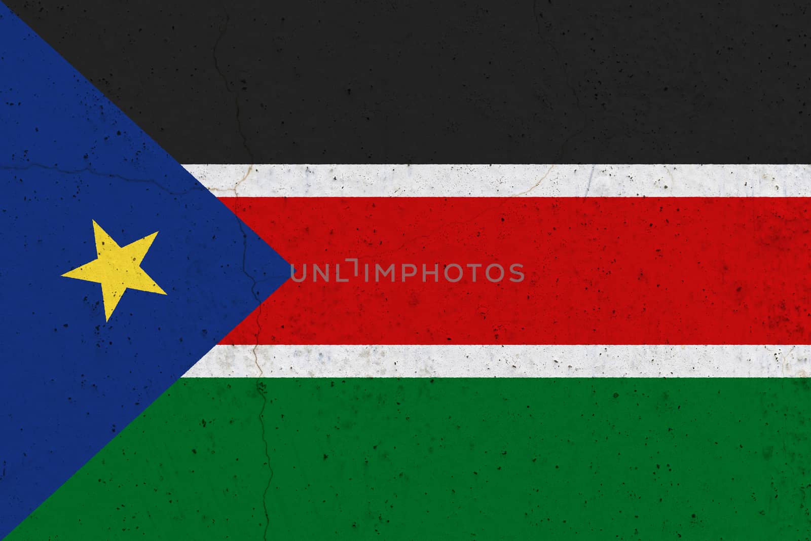 South Sudan flag on concrete wall. Patriotic grunge background. National flag of South Sudan