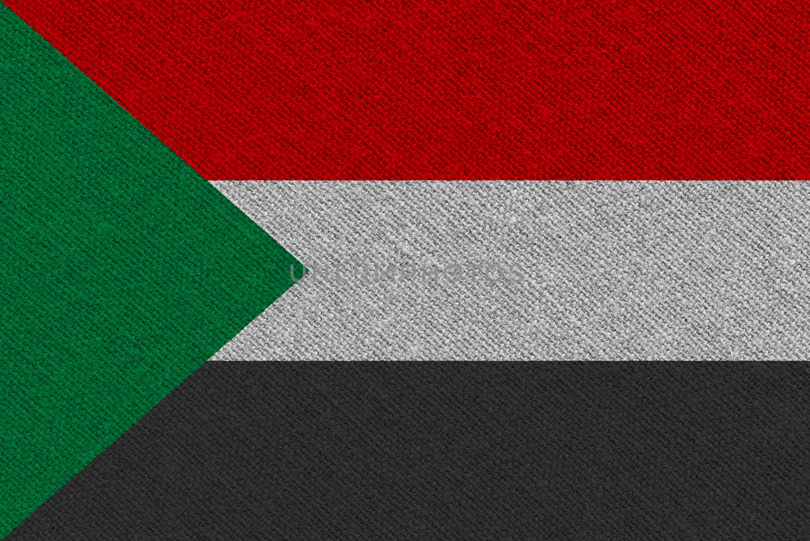 Sudan fabric flag. Patriotic background. National flag of Sudan