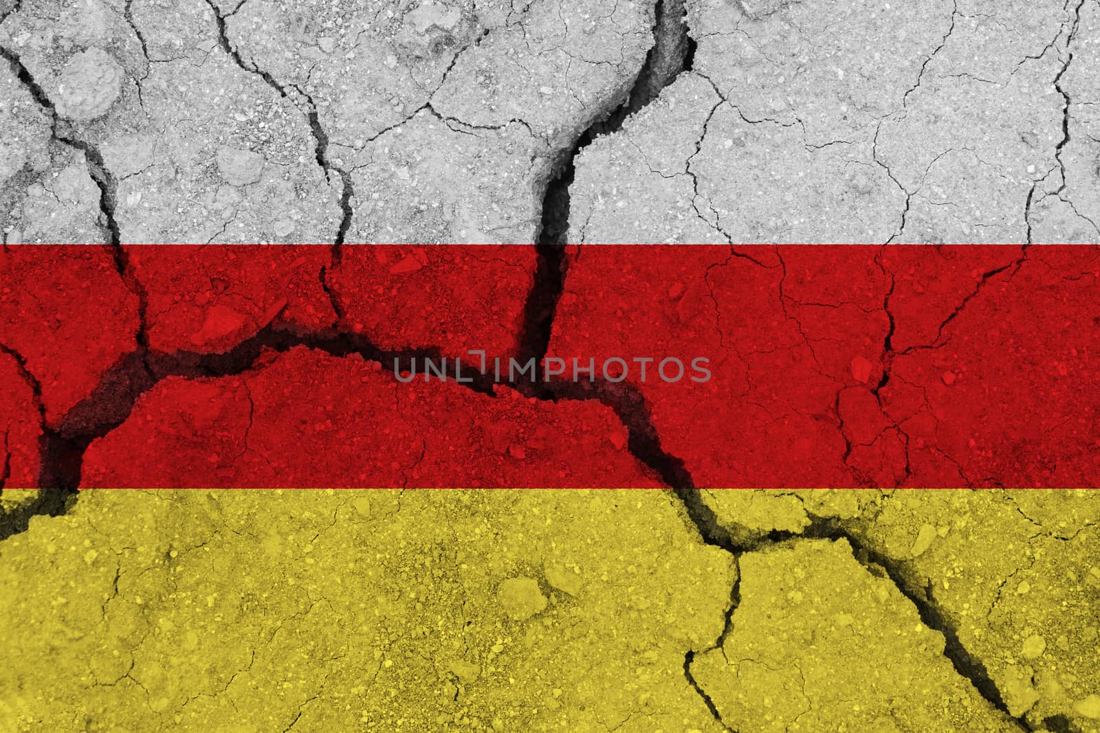 south ossetia flag on the cracked earth by Visual-Content