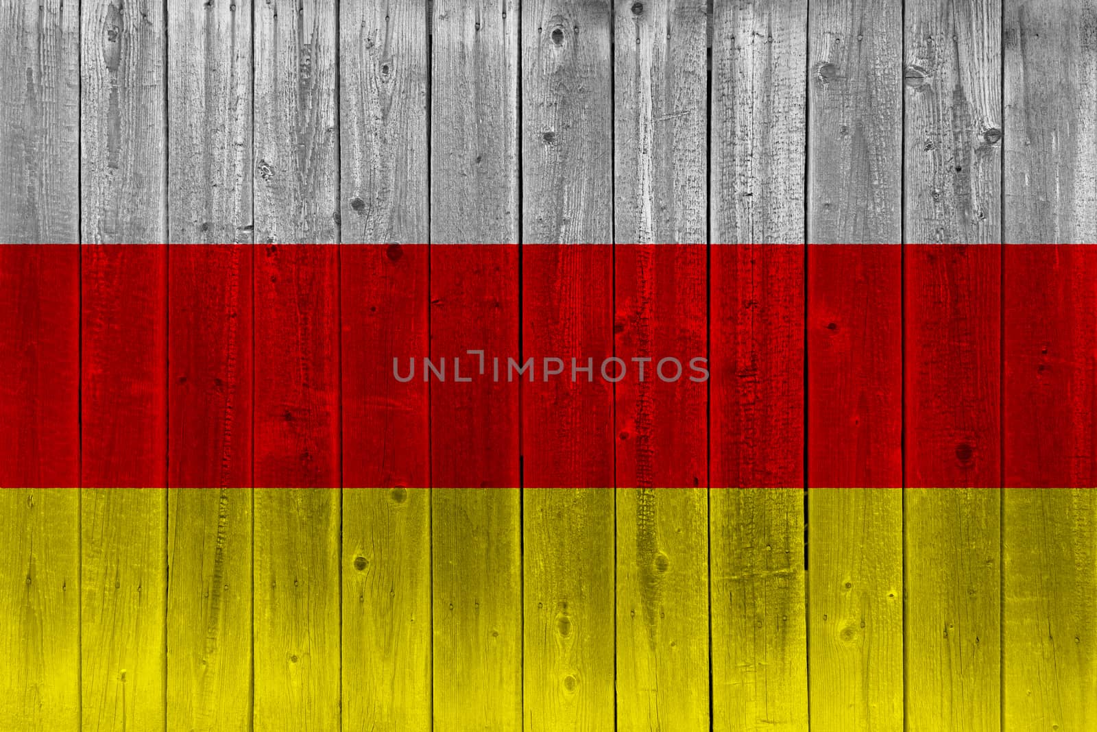 South ossetia flag painted on old wood plank. Patriotic background. National flag of South ossetia