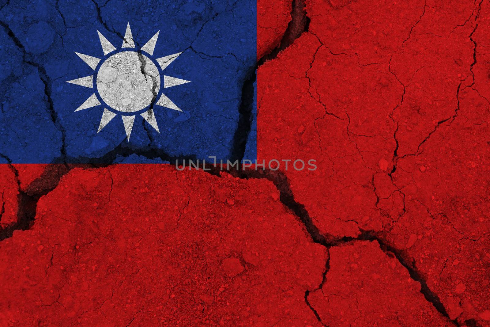 Taiwan flag on the cracked earth. National flag of Taiwan. Earthquake or drought concept