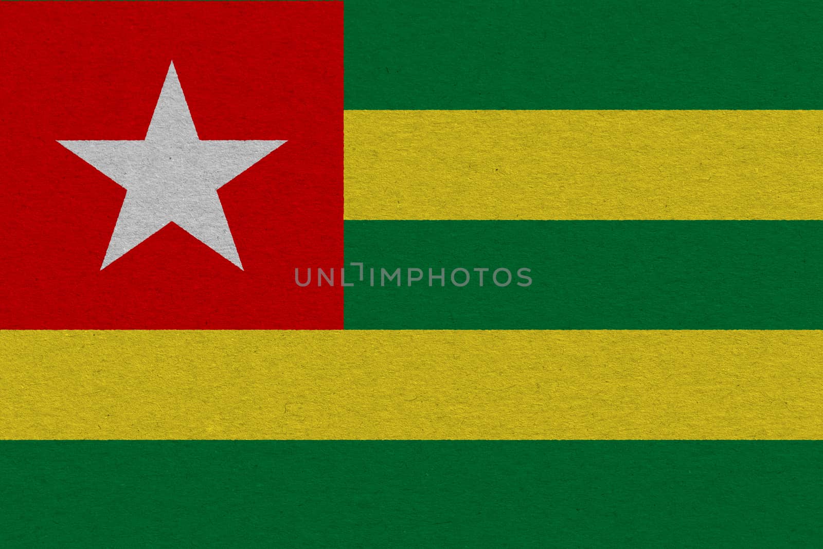 Togo flag painted on paper. Patriotic background. National flag of Togo