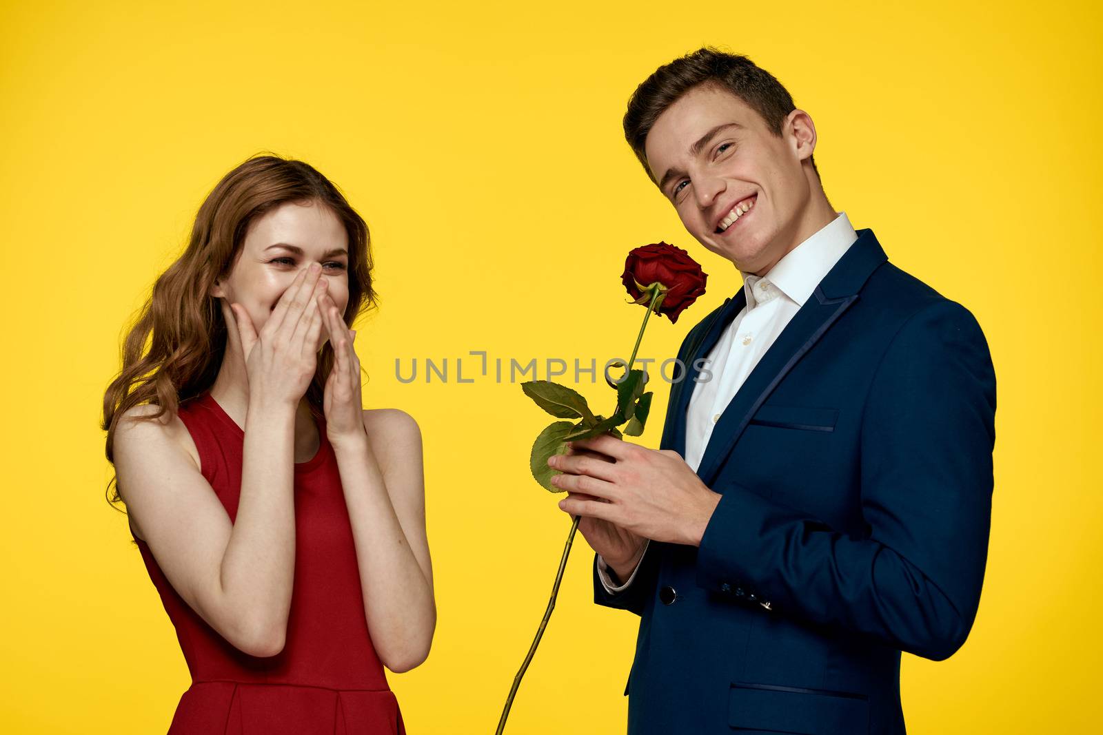 Lovers men woman with red rose in hands romance holidays yellow background family friends. by SHOTPRIME