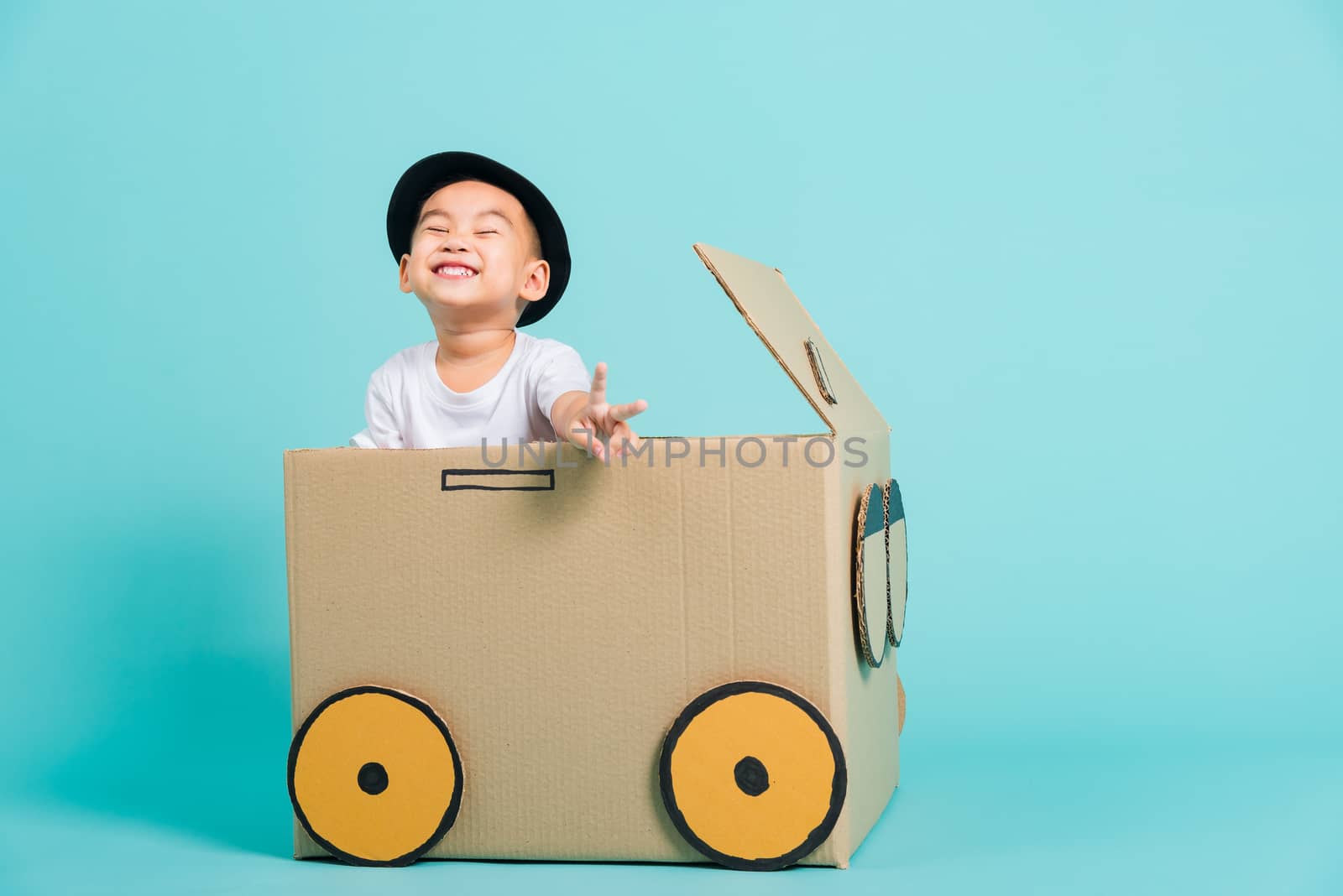 Baby children boy smile in driving play car creative by a cardbo by Sorapop