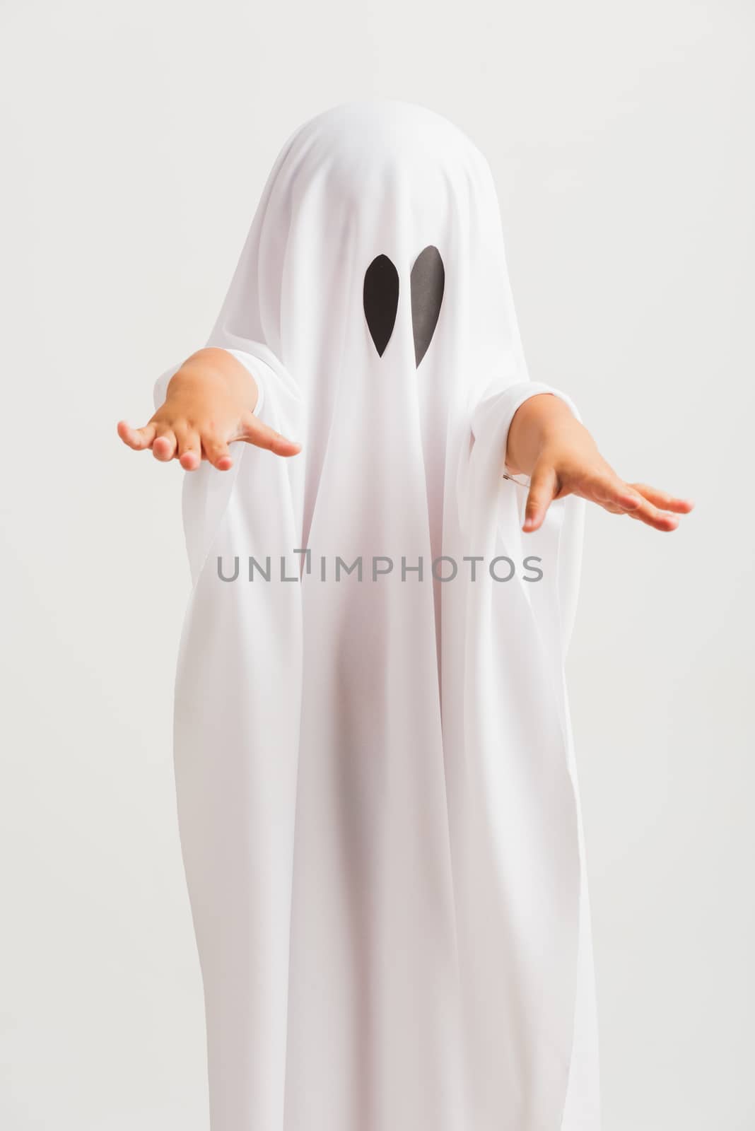 Funny Halloween Kid Concept, little cute child with white dressed costume halloween ghost scary, studio shot isolated on white background