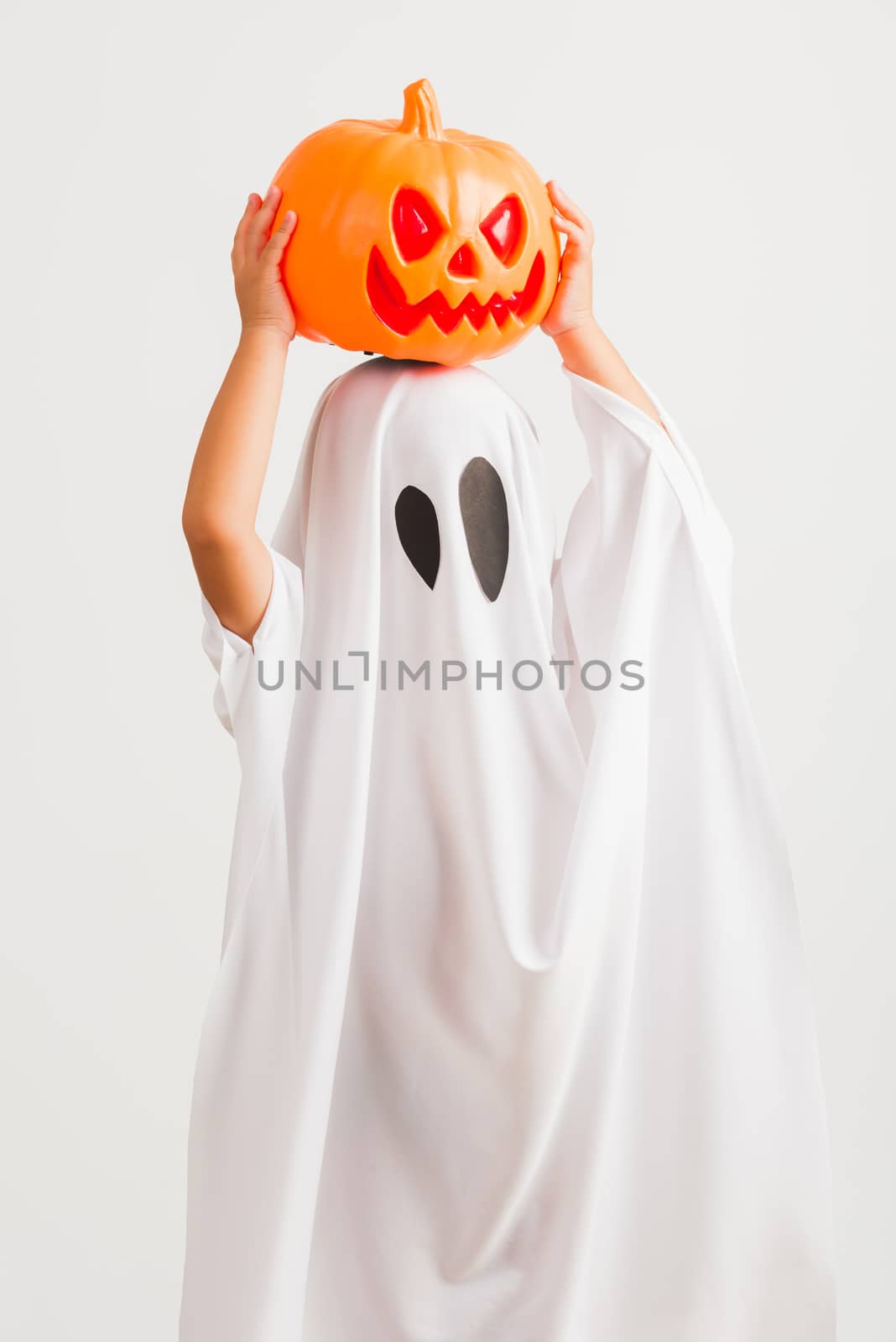 child with white dressed costume halloween ghost scary he holdin by Sorapop