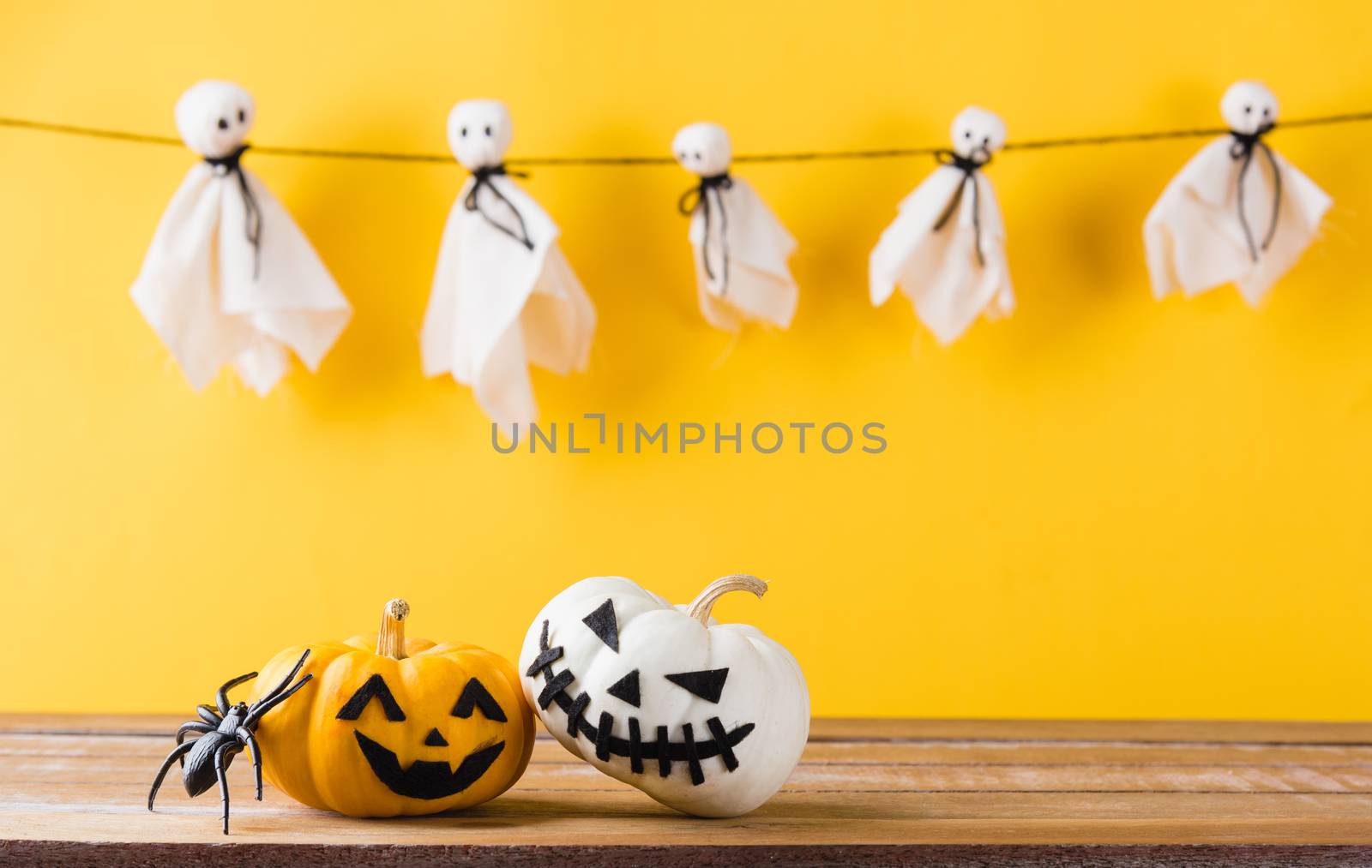 halloween pumpkin head jack lantern smile and spider on wooden by Sorapop