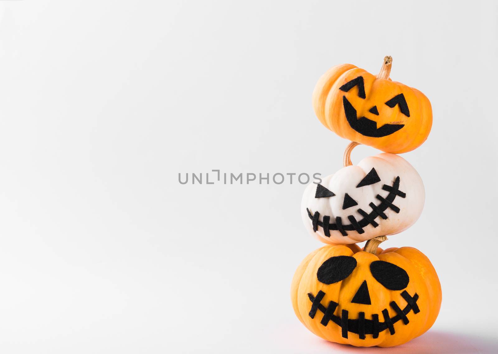 Funny Halloween day party concept ghost pumpkin head jack lantern scary smile and stack together, studio shot isolated on white background, Holiday decoration