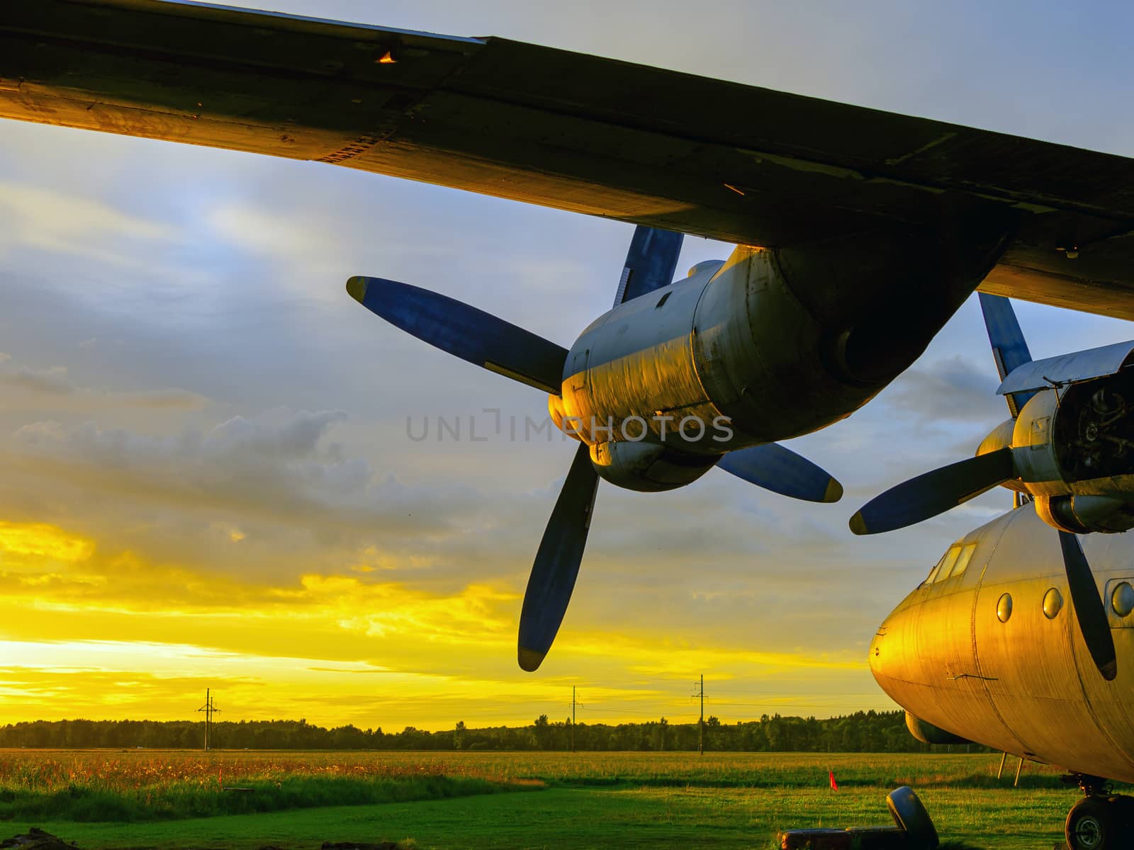 old Soviet military airplane, sunset time. Abandoned Historic Aircraft in Estonia AN-12. Close up of propeller engine. Copy space