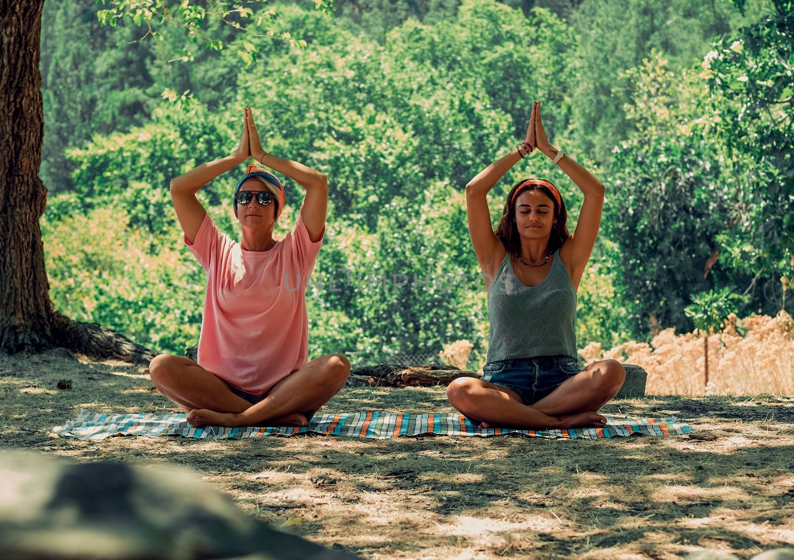 Adults sitting in lotus position.