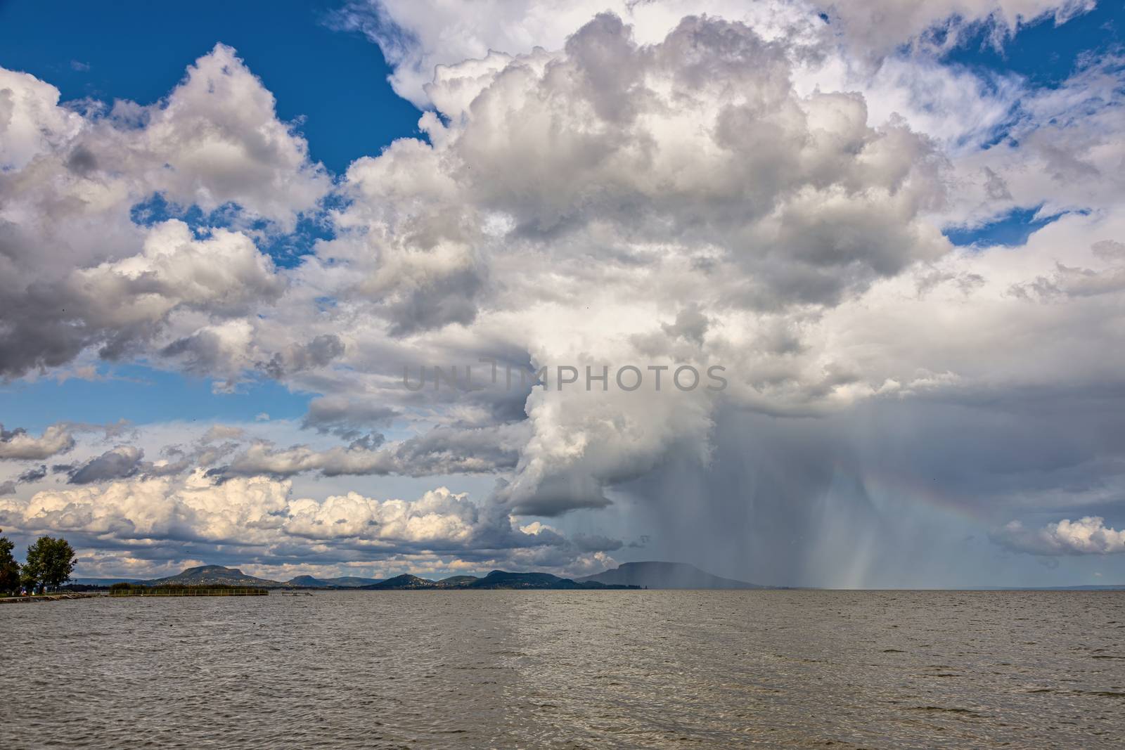 Shower over the Lake Balaton of Hungary in summertime by Digoarpi