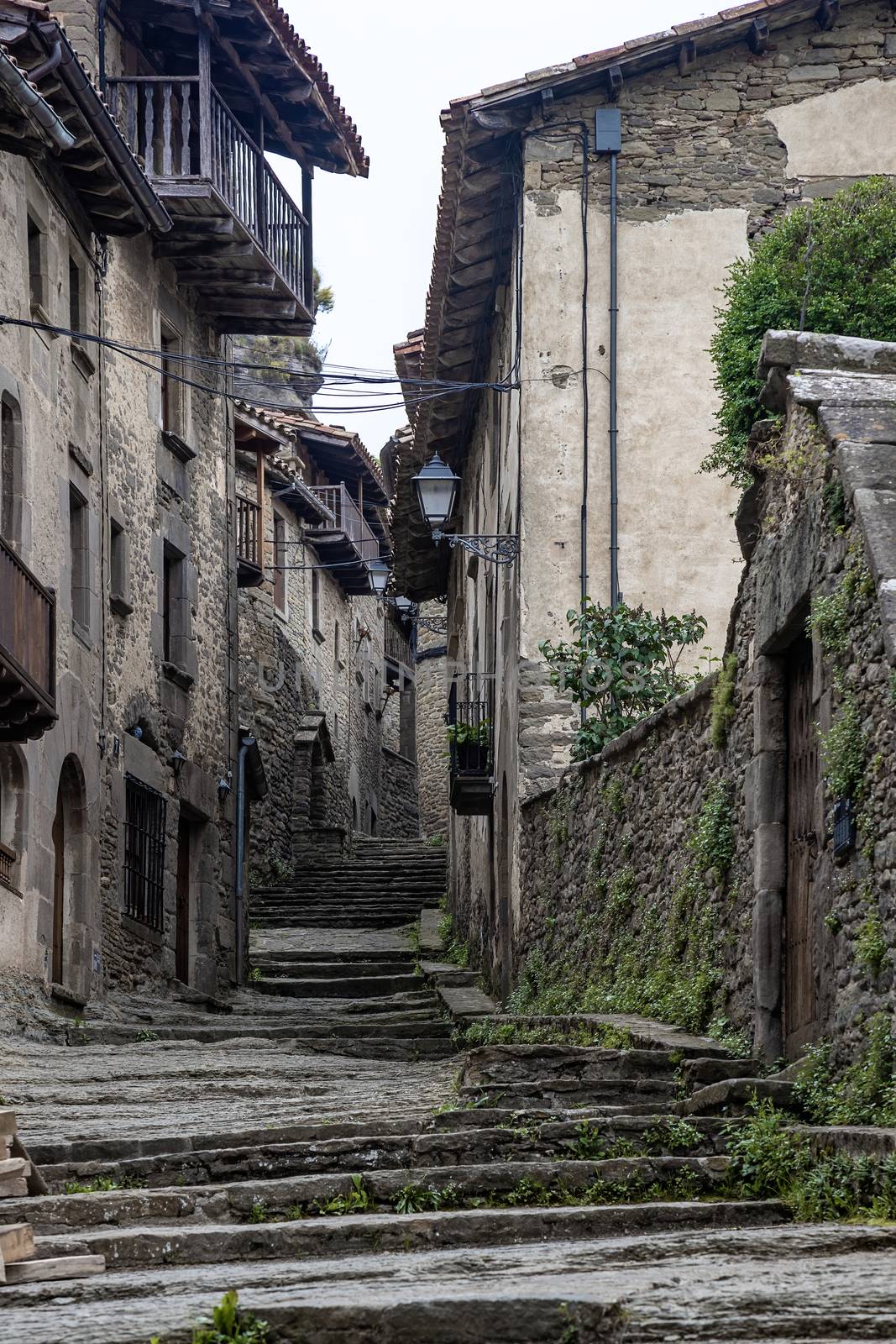 Streets of medieval village of Rupit, Catalonia of Spain by Digoarpi
