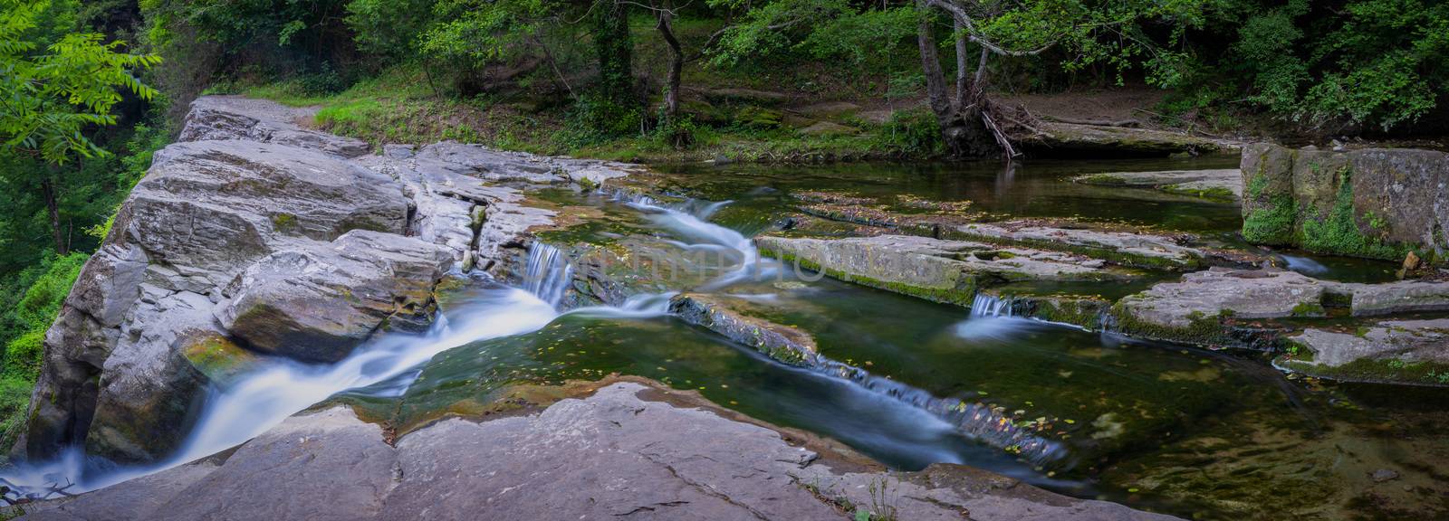 Panoramic picture ,small forest creek with waterfall