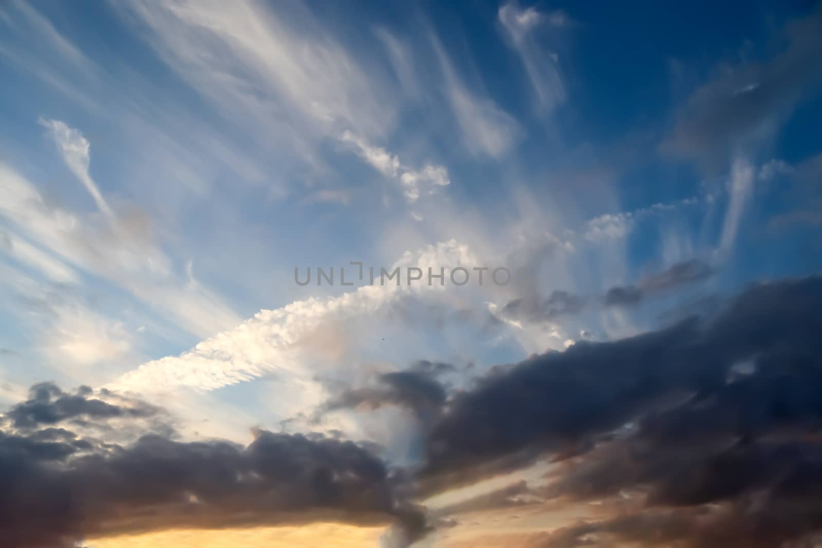 Beautiful panorama of orange and yellow clouds at sunrise and sunset in a blue sky