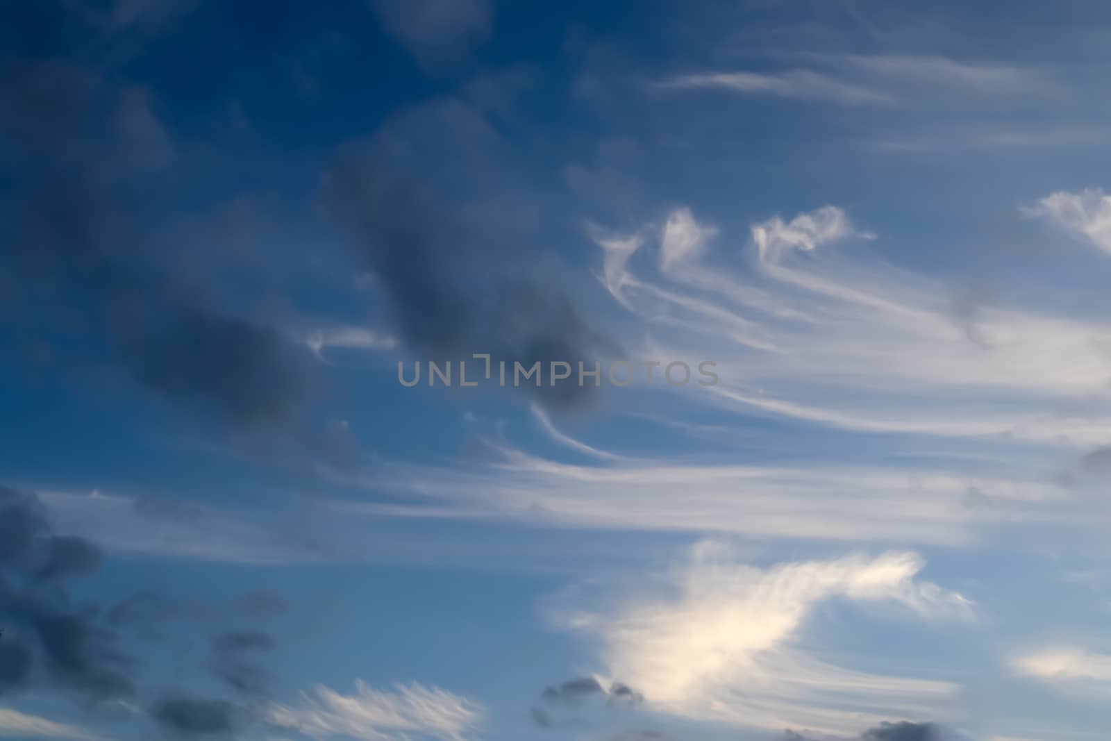 Beautiful panorama of orange and yellow clouds at sunrise and sunset in a blue sky