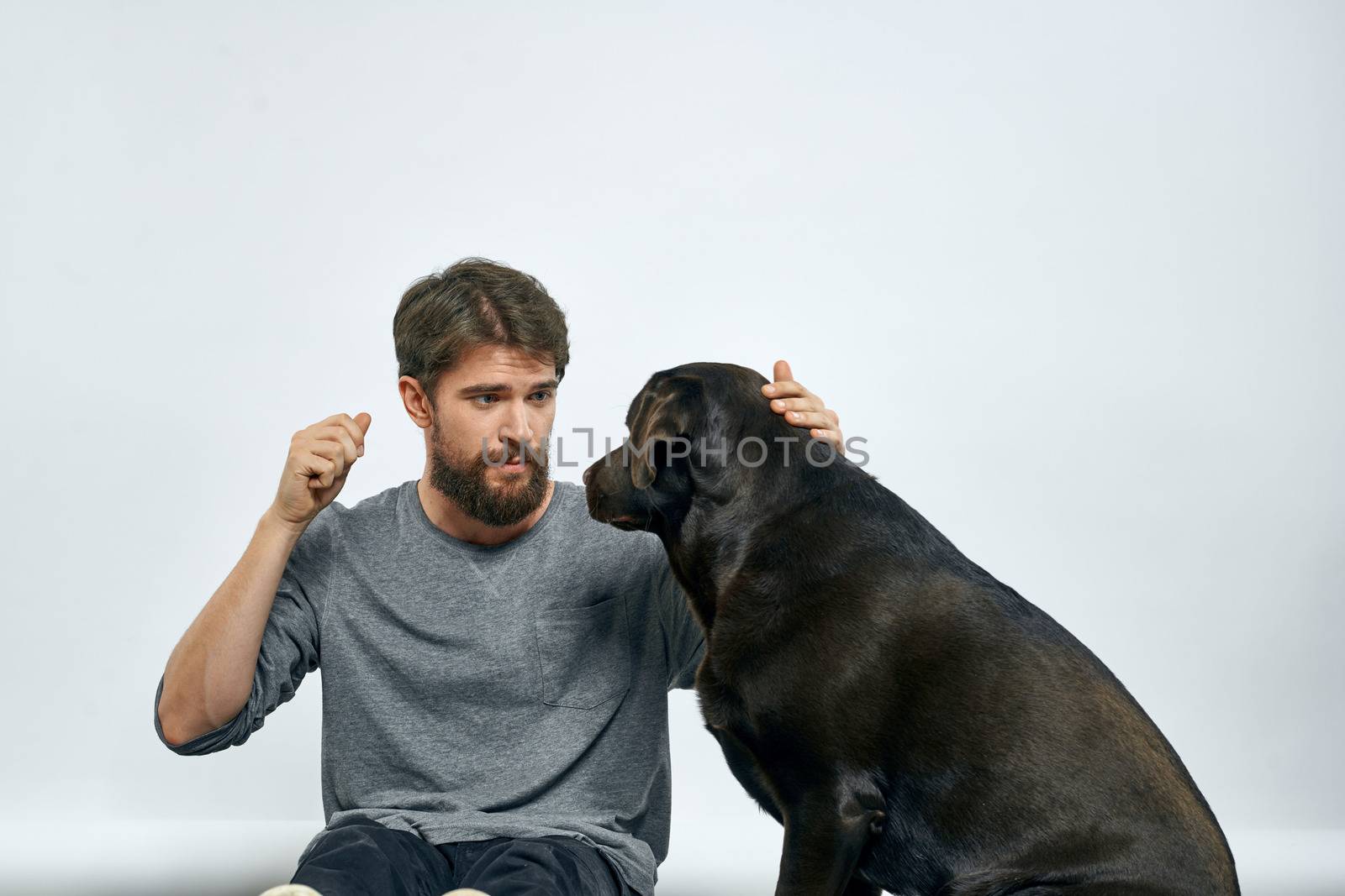 happy owner with pet black dog training model emotions. High quality photo