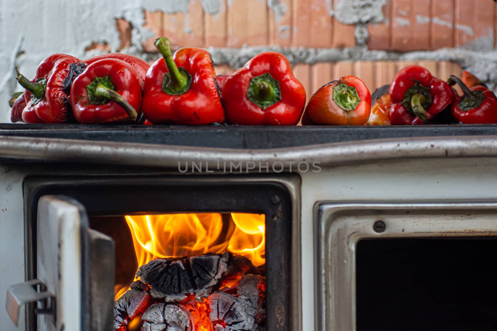 Old stove with paprika baking on top of it outside the house