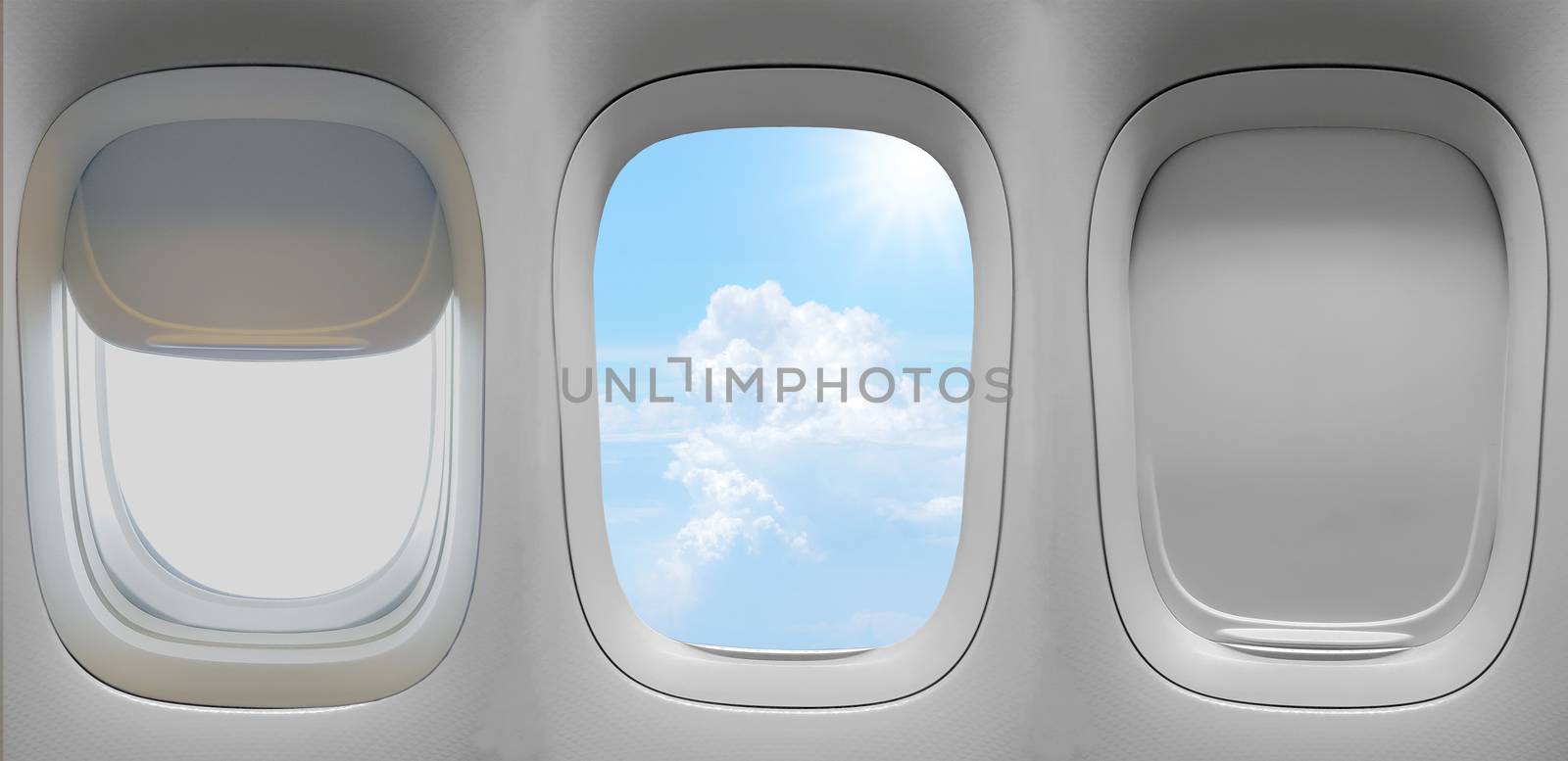 Closeup group of the airplane windows with the clouds sky background.
