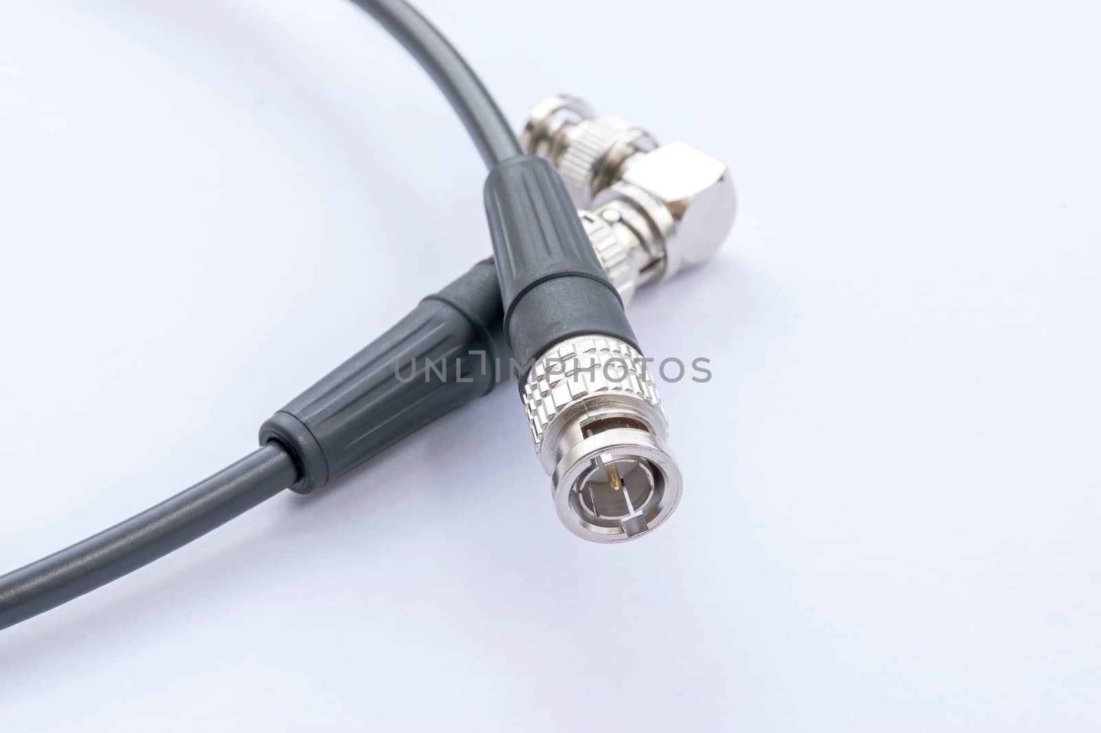 BNC connector jack with cable for video signal isolated on white background.