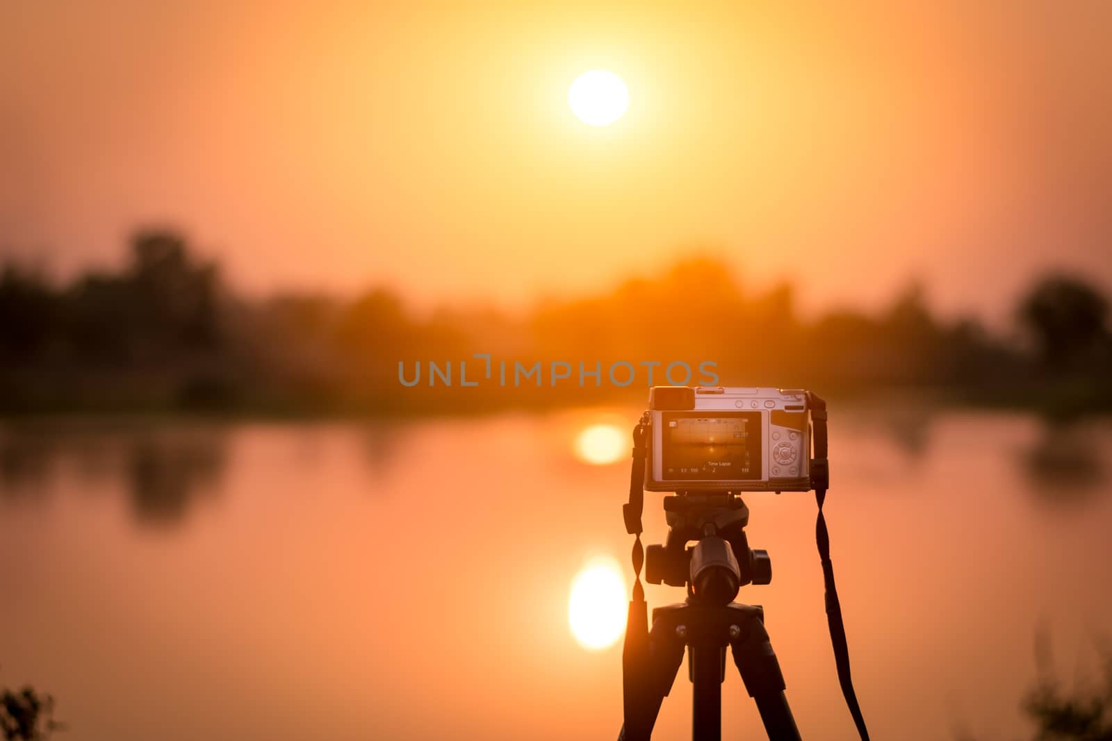 Set the camera on a tripod to record time-lapse video of the sunset.