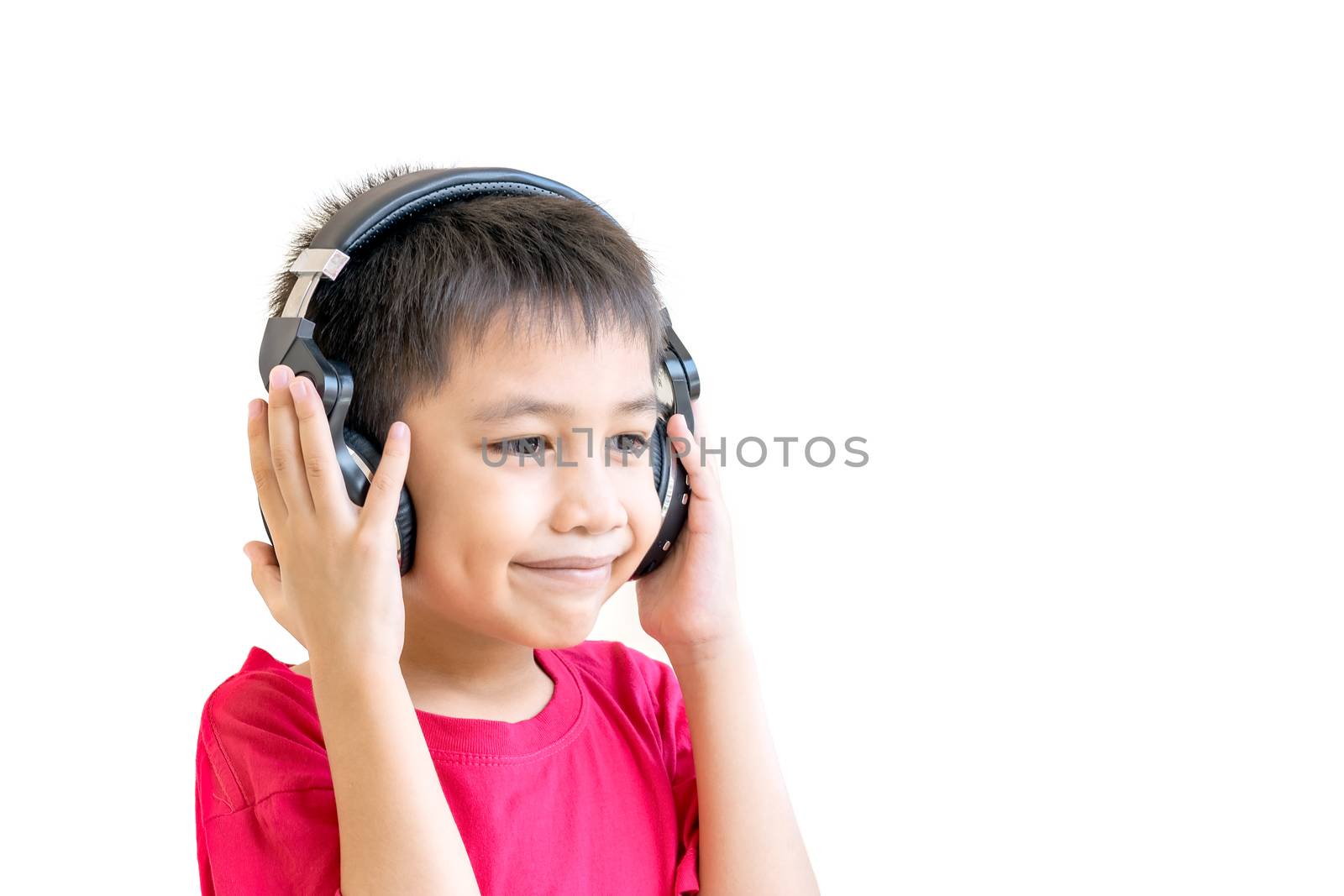 Asian boy wearing a red shirt and wear wireless headphones to listen to music and smiling happily.