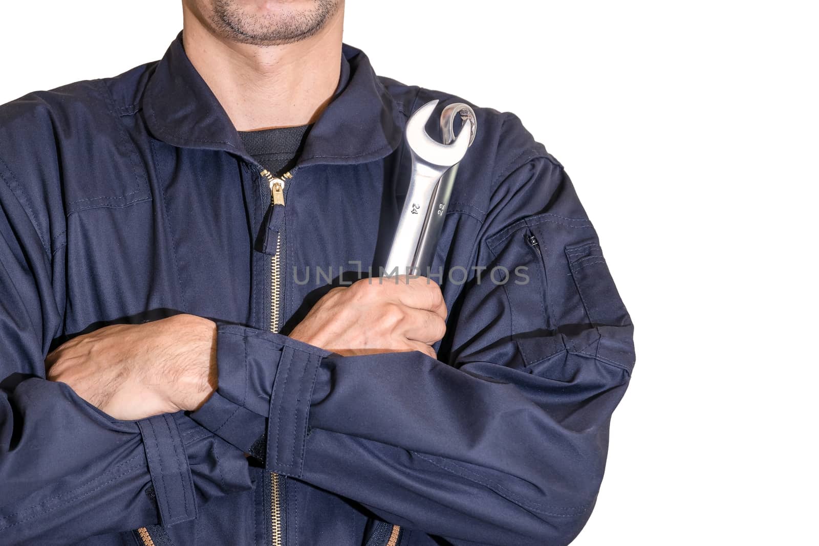 Car repairman wearing a dark blue uniform standing and holding a wrench that is an essential tool for a mechanic isolated on white background, Automotive industry and garage concepts.