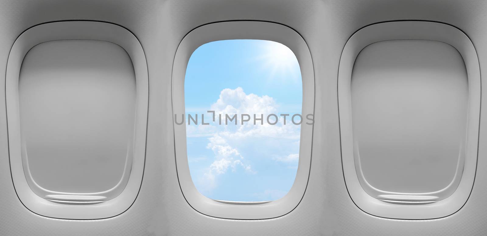 Closeup group of the airplane windows with the clouds sky background.