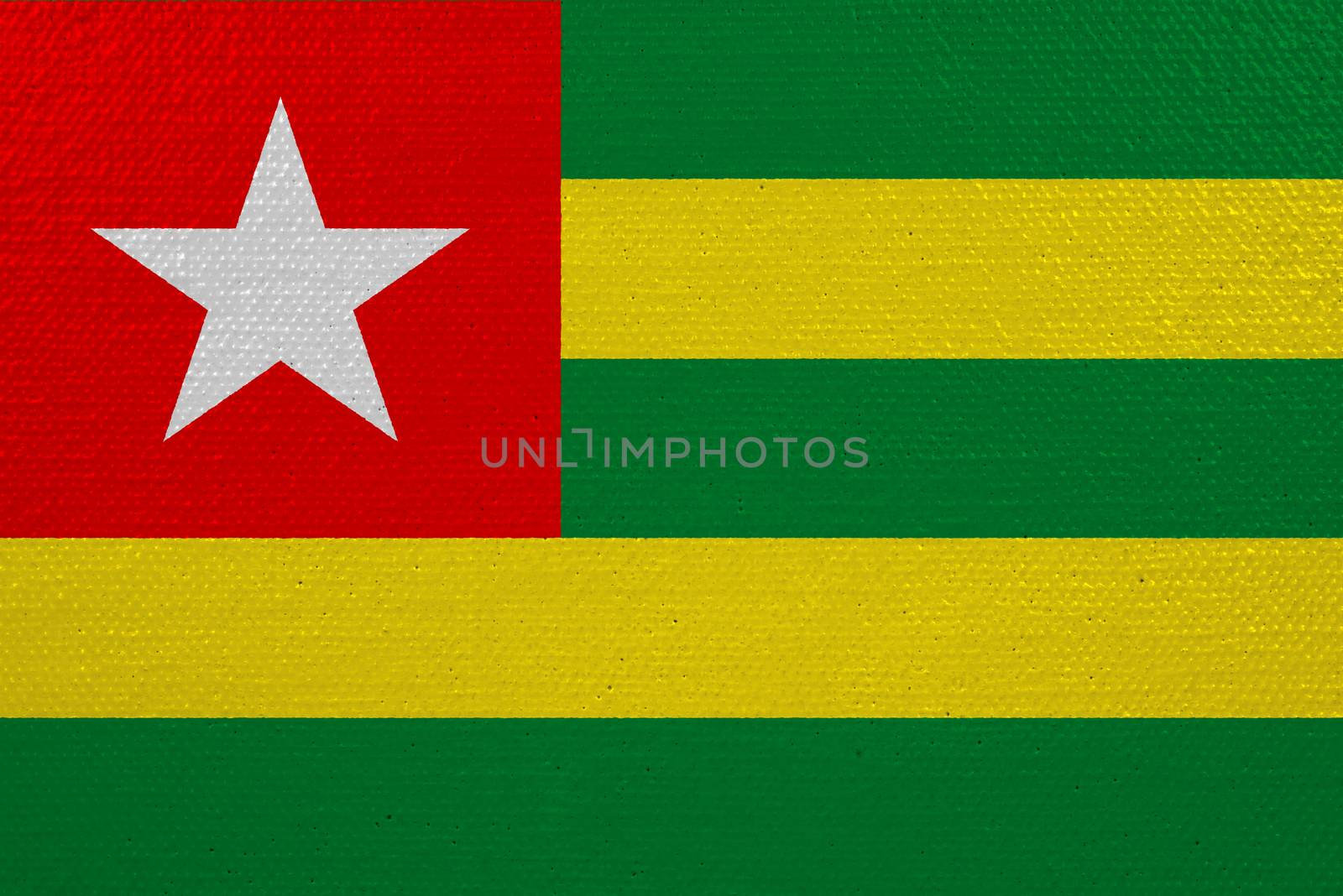 Togo flag on canvas. Patriotic background. National flag of Togo