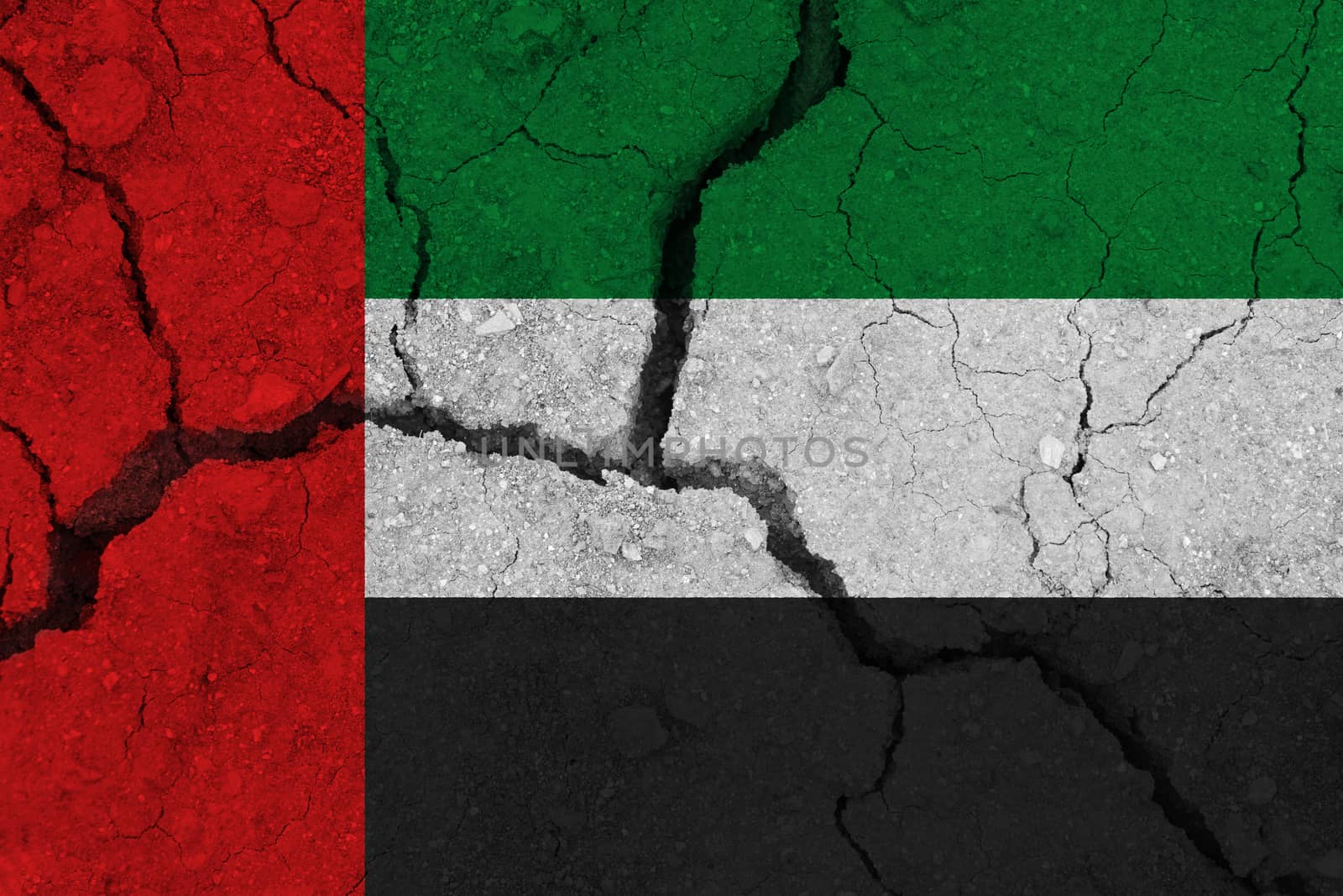 United arab flag on the cracked earth. National flag of United arab. Earthquake or drought concept