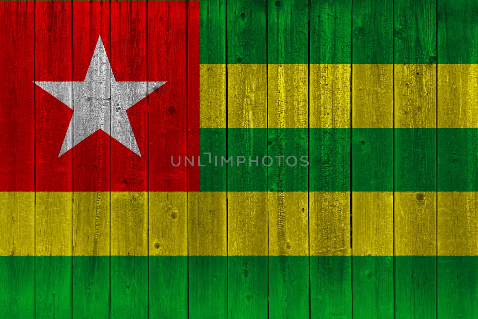 Togo flag painted on old wood plank. Patriotic background. National flag of Togo